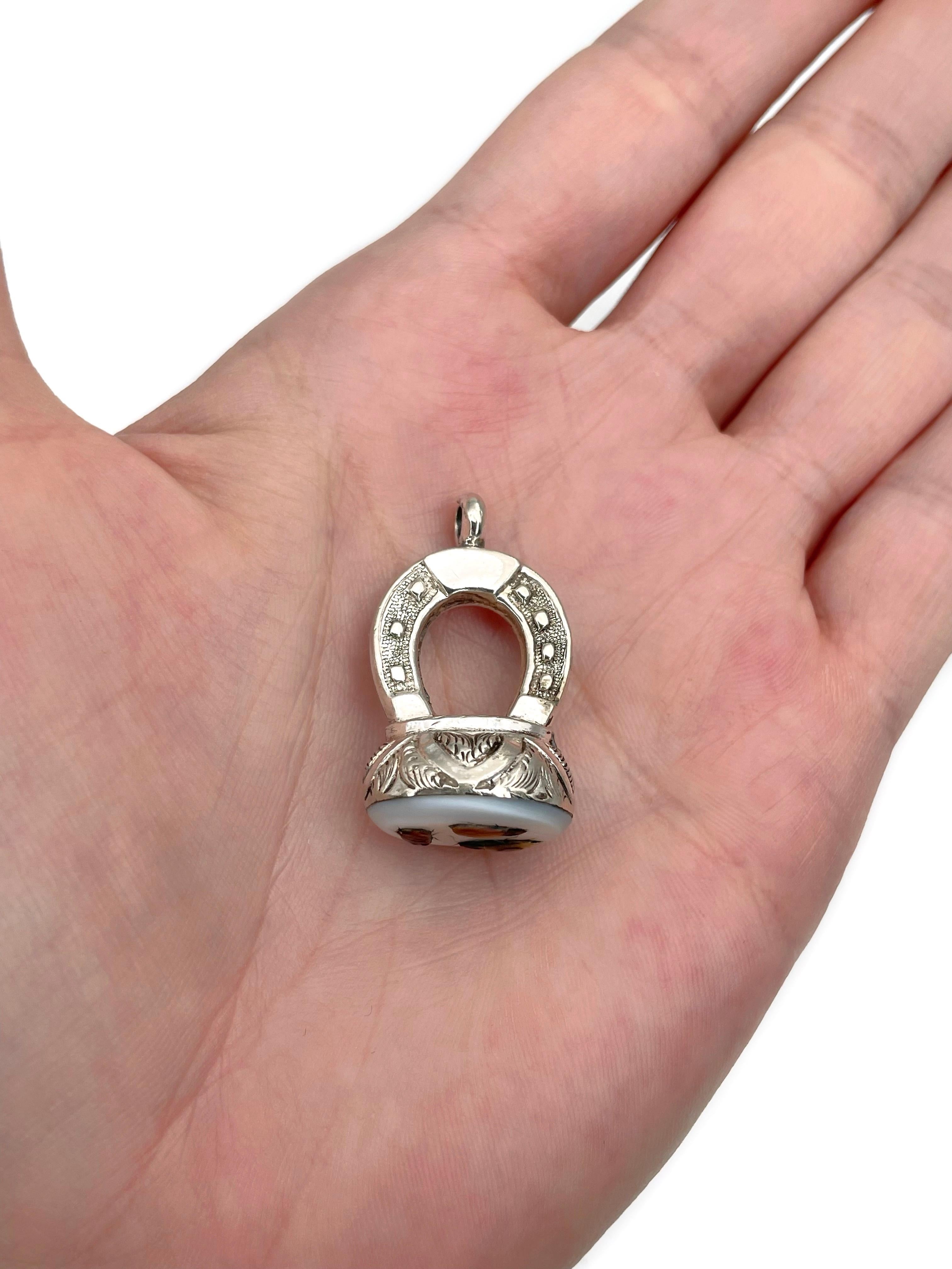 This is a Victorian horseshoe shape fob pendant. It is crafted in silver tone metal. The base of the piece depicts three insects on white base. Circa 1880.

Weight: 12.30g
Pendant length: 3cm
Base size: 1.7x1.5cm

IMPORTANT: As a buyer, you are