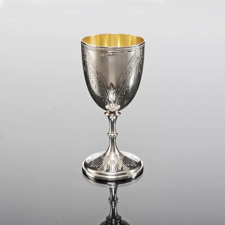 Elegant antique silver goblet with most unusual and beautifully executed hand engraved patterns, combining engine turned panels of fox-head pattern, drapery, inverted beading and foliage. This decoration is in the most wonderful crisp condition,