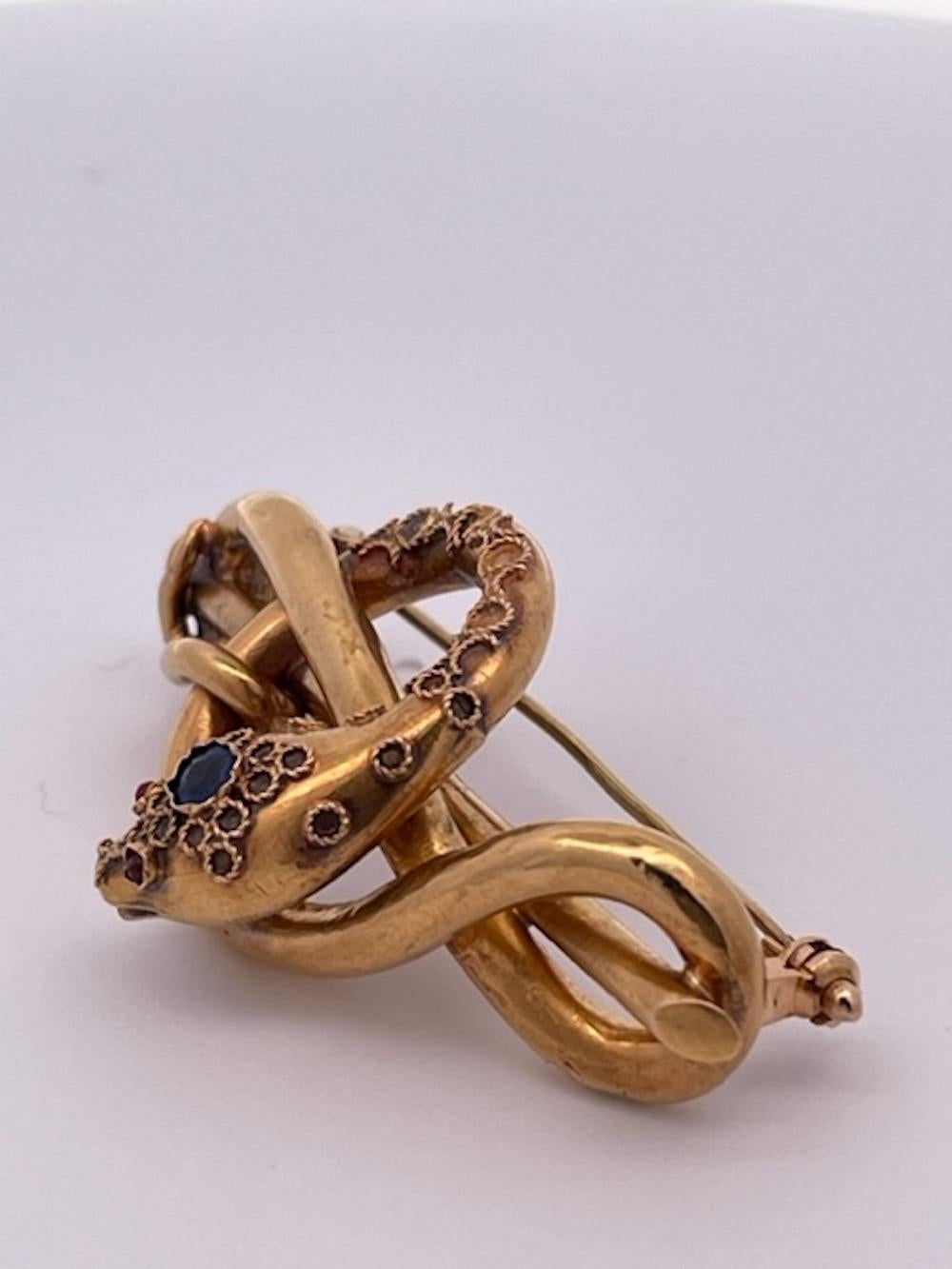 This Victorian snake brooch is just beautiful.  It has pink and Blue stones detailed and chased with scroll work completely detailed on the front with a smooth back. I rarely find chased and detailed snake brooch such as this. The brooch is