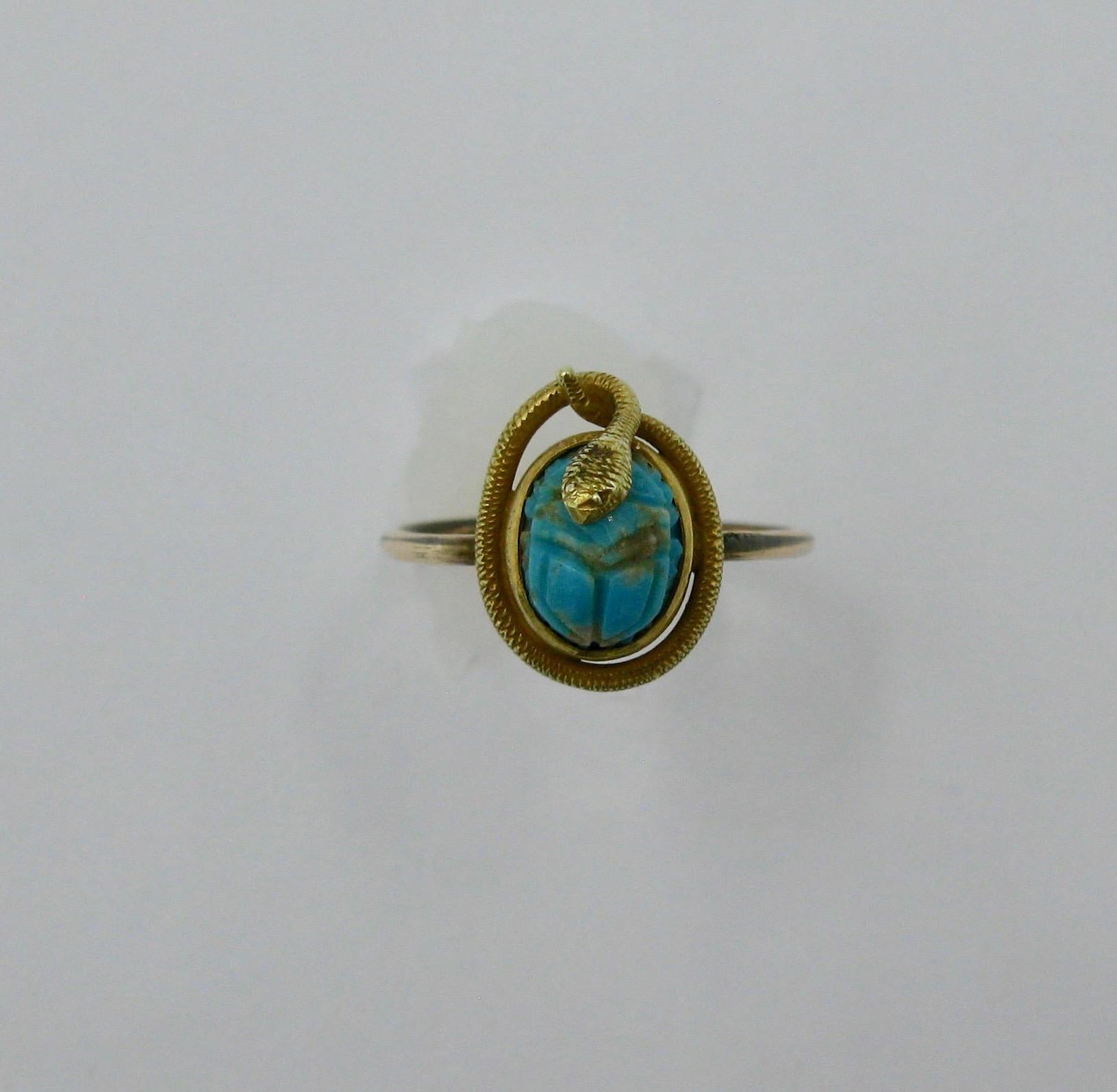 This is a very rare antique Egyptian Revival Ring with a snake curled around a Turquoise Scarab - how wonderful!  The Scarab is hand carved of natural Persian Turquoise.  The serpent snake wraps around the scarab.   The snake is beautifully detailed