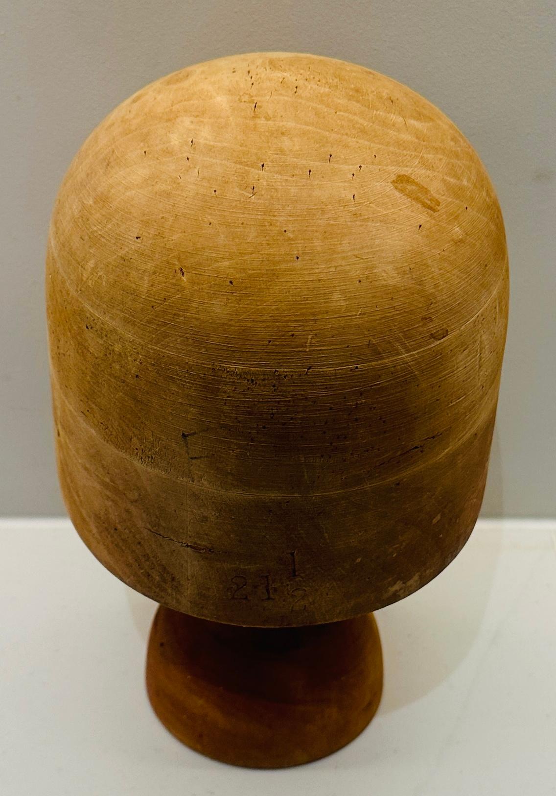 Early 20th Century Victorian solid beech millinery block stand in a lovely used unfinished natural condition. The numerous pin marks from years of making hats add to its character and provenance. The block stands on a custom made matching removable