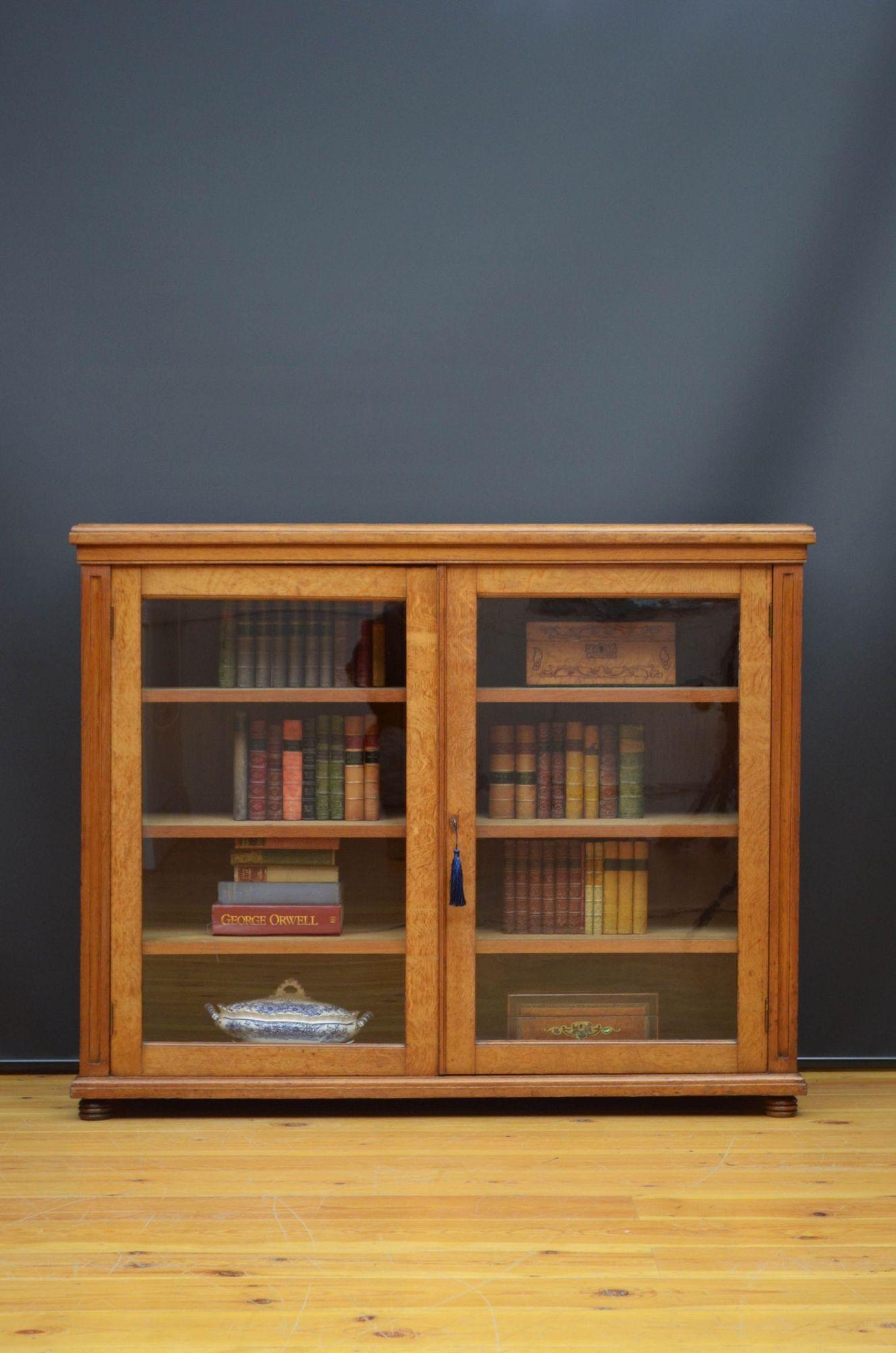 Sm5451 Victorian solid oak glazed bookcase or display cabinet, having solid oak top with moulded edge above a pair of glazed door fitted with working lock and a key and enclosing three height adjustable shelves, all flanked by moulded pilasters, all