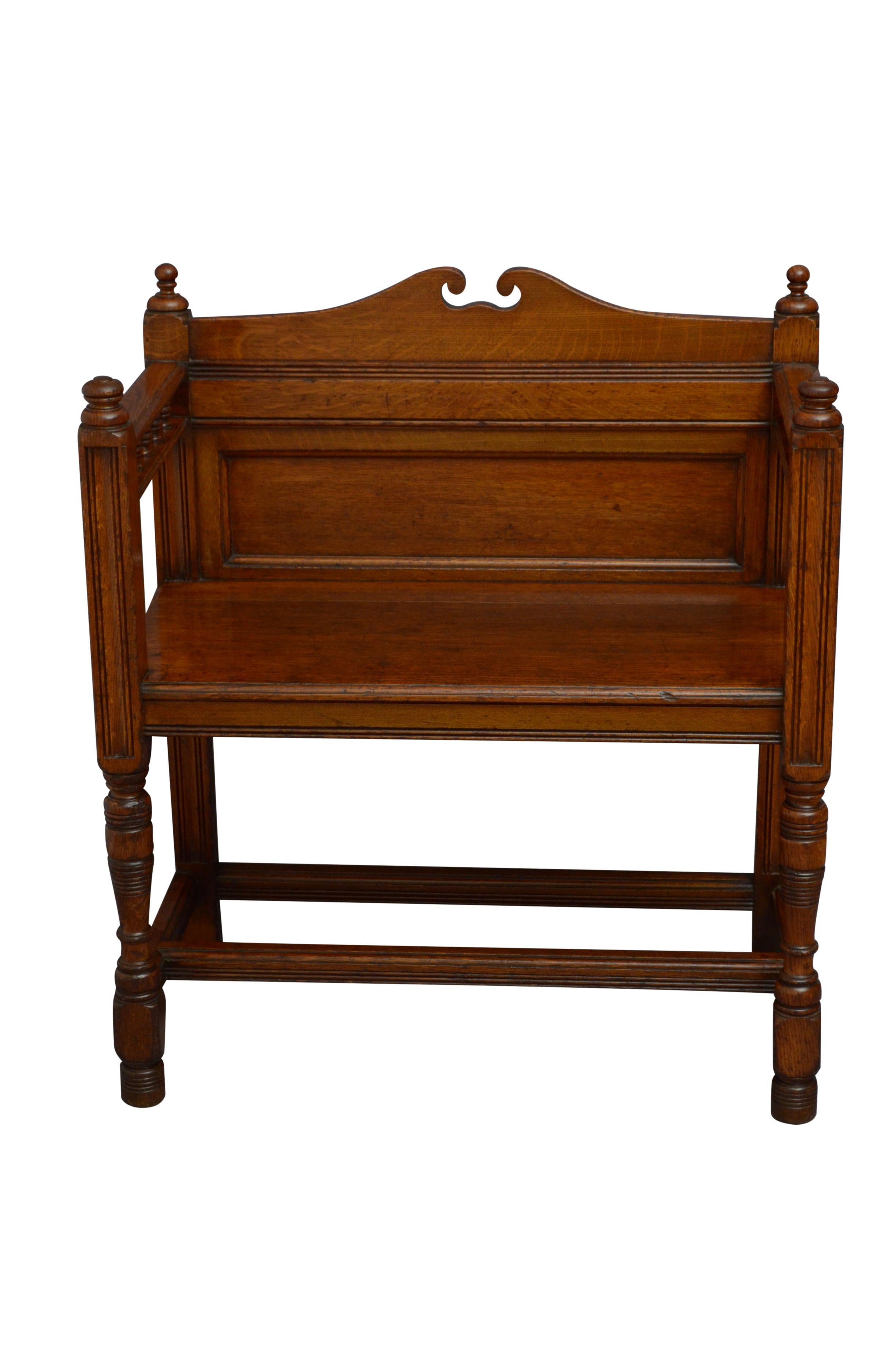 K0518 Very attractive Victorian hall seat, having shaped top rail with moulded and panelled back, open arms with decorative spindles and moulded seat, standing on panelled supports terminating in turned legs united by double stretchers. This antique