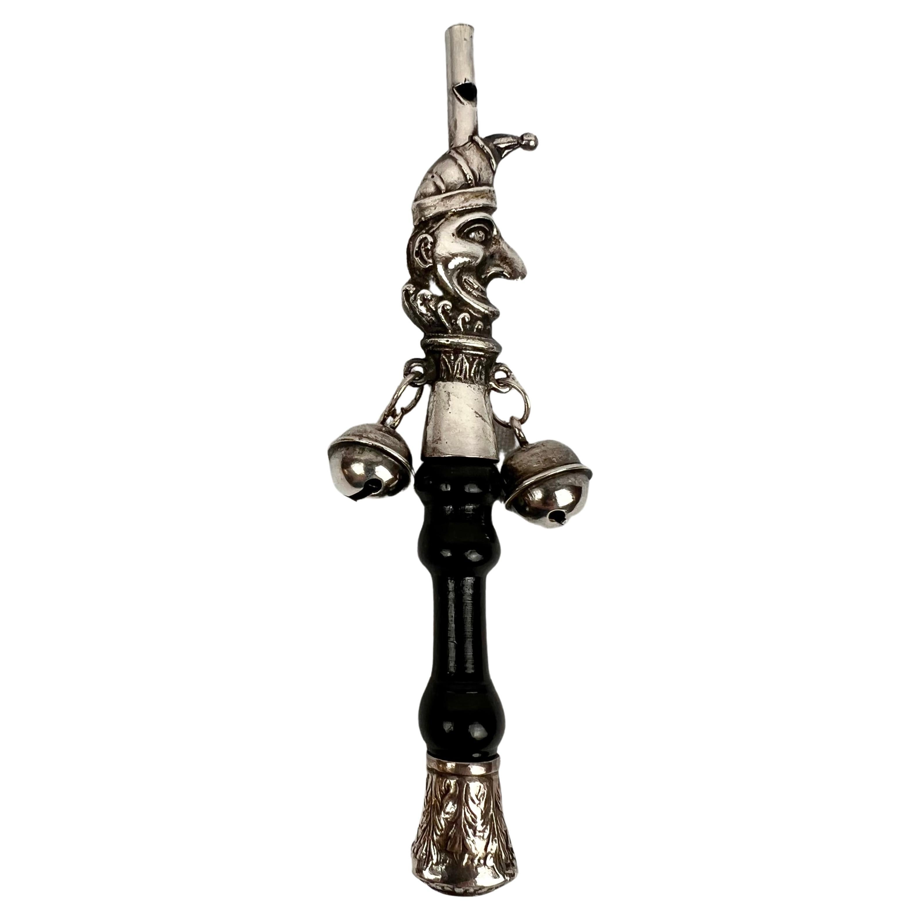 The Jester, a Victorian Solid Silver Form Baby Rattle with Ebony Turned Handle