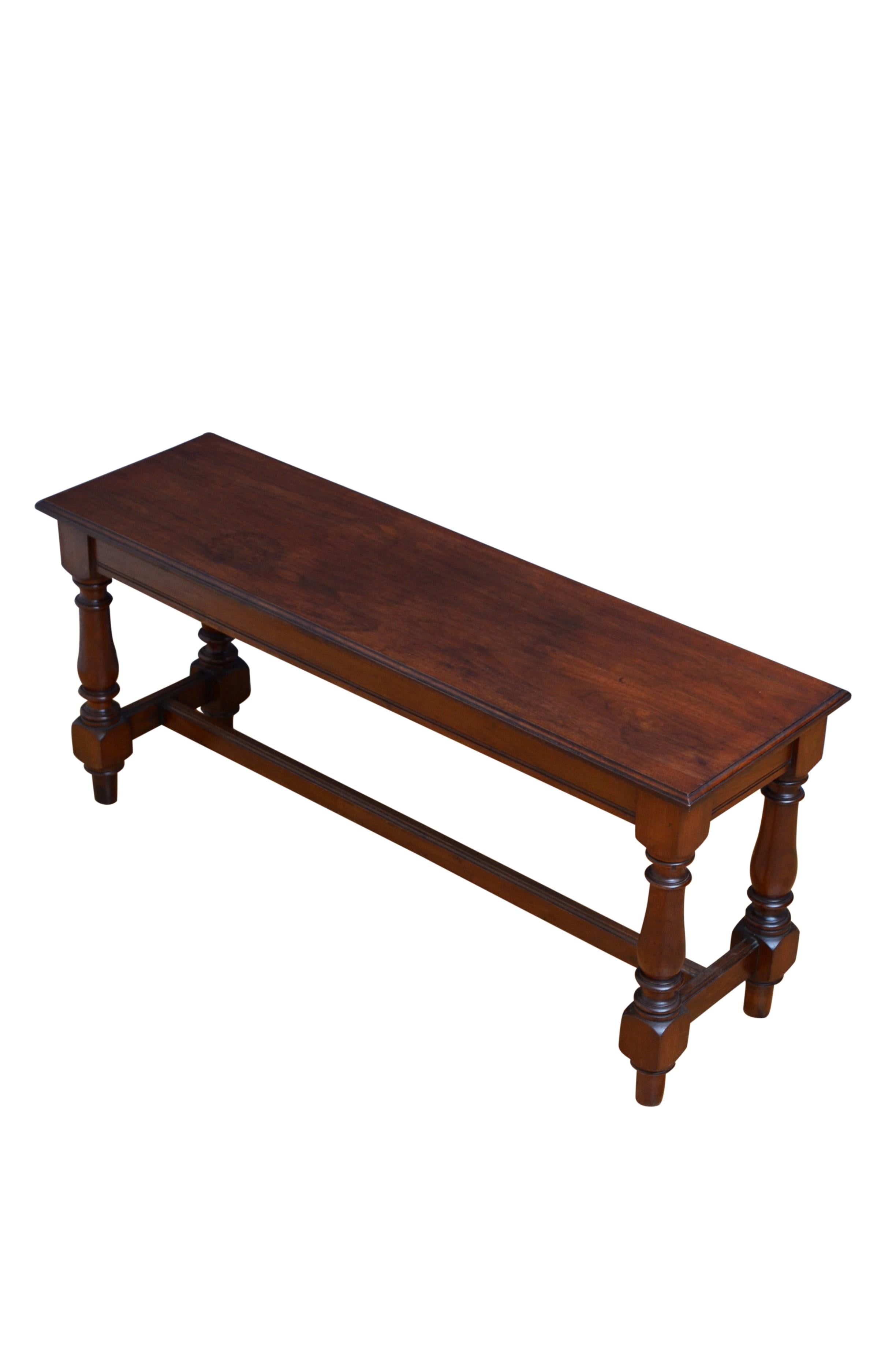 K0561 A substantial walnut hall seat, having solid, figured walnut seat with moulded edge above shallow reeded frieze, standing on baluster legs united by stretchers. This antique bench is in home ready condition, retaining its antique character and
