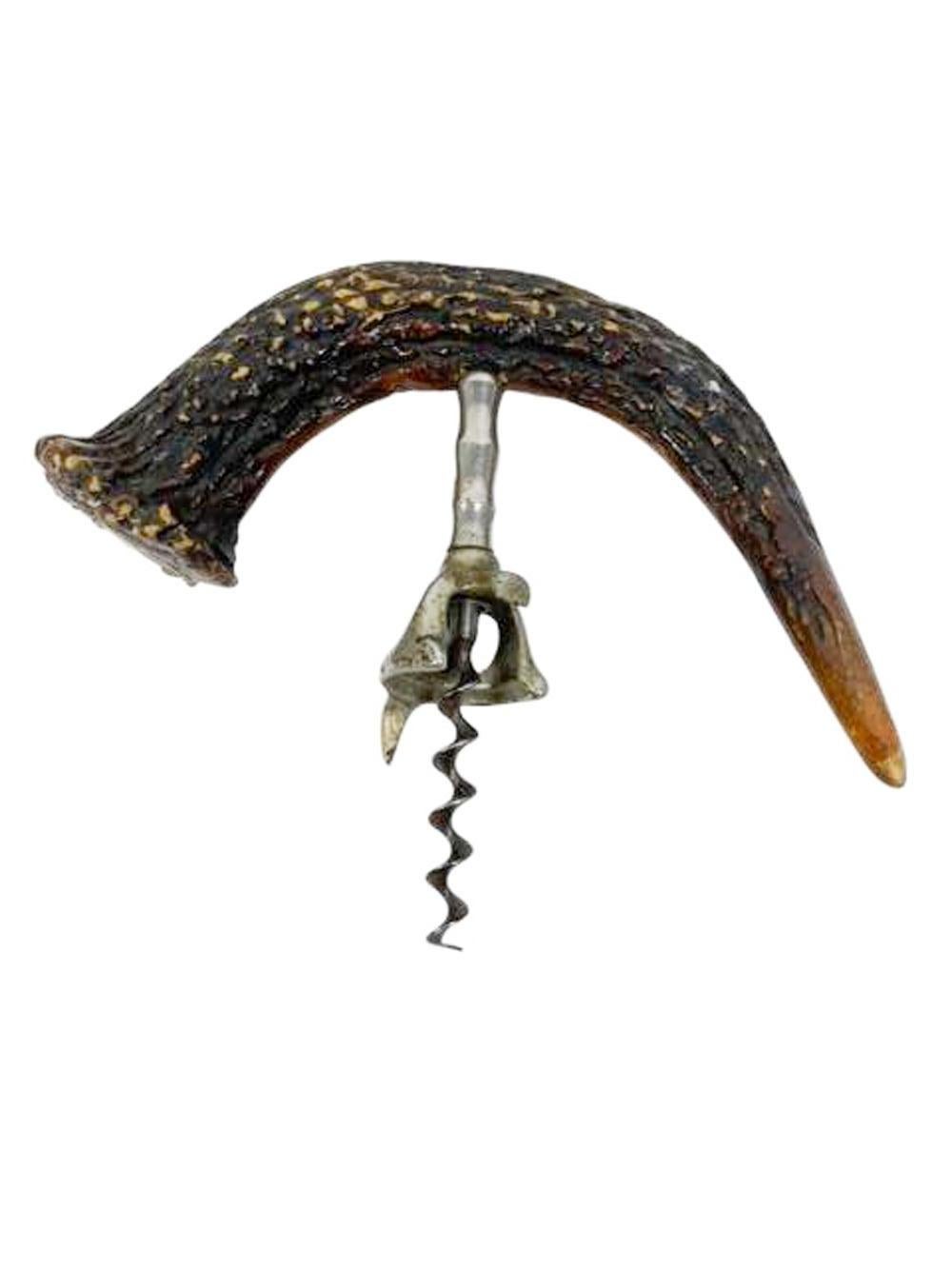Seven inch wide stag horn handled corkscrew with curved handle having a silver cartouche applied to the butt end (no monogram).