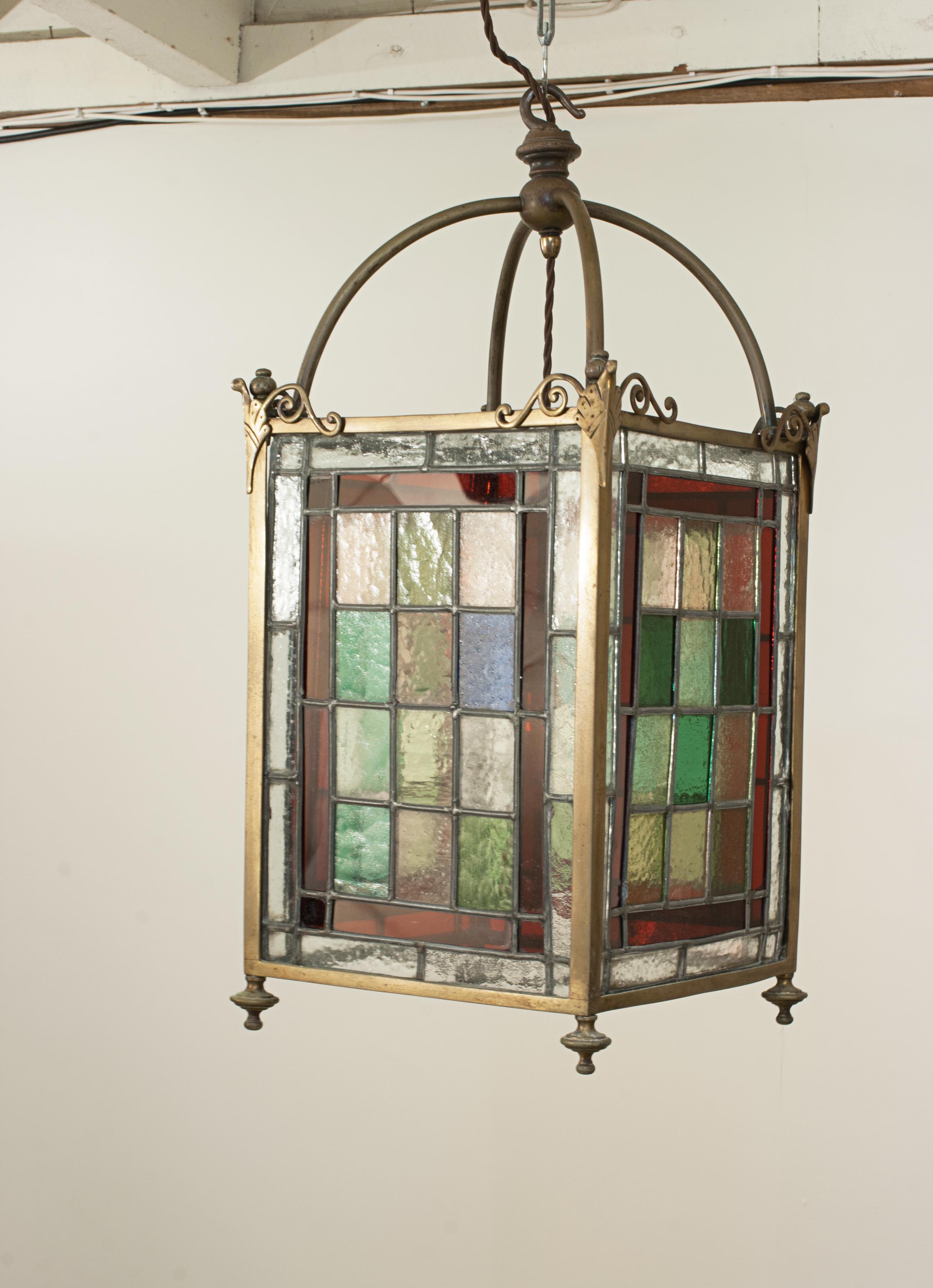 Victorian Stain Glass Ceiling Pendant Lantern.
A highly attractive and decorative ceiling light that will enhance any interior entrance or hallway. The four-sided leaded glass hall lantern has an antique brass frame with a small ceiling rose to hang