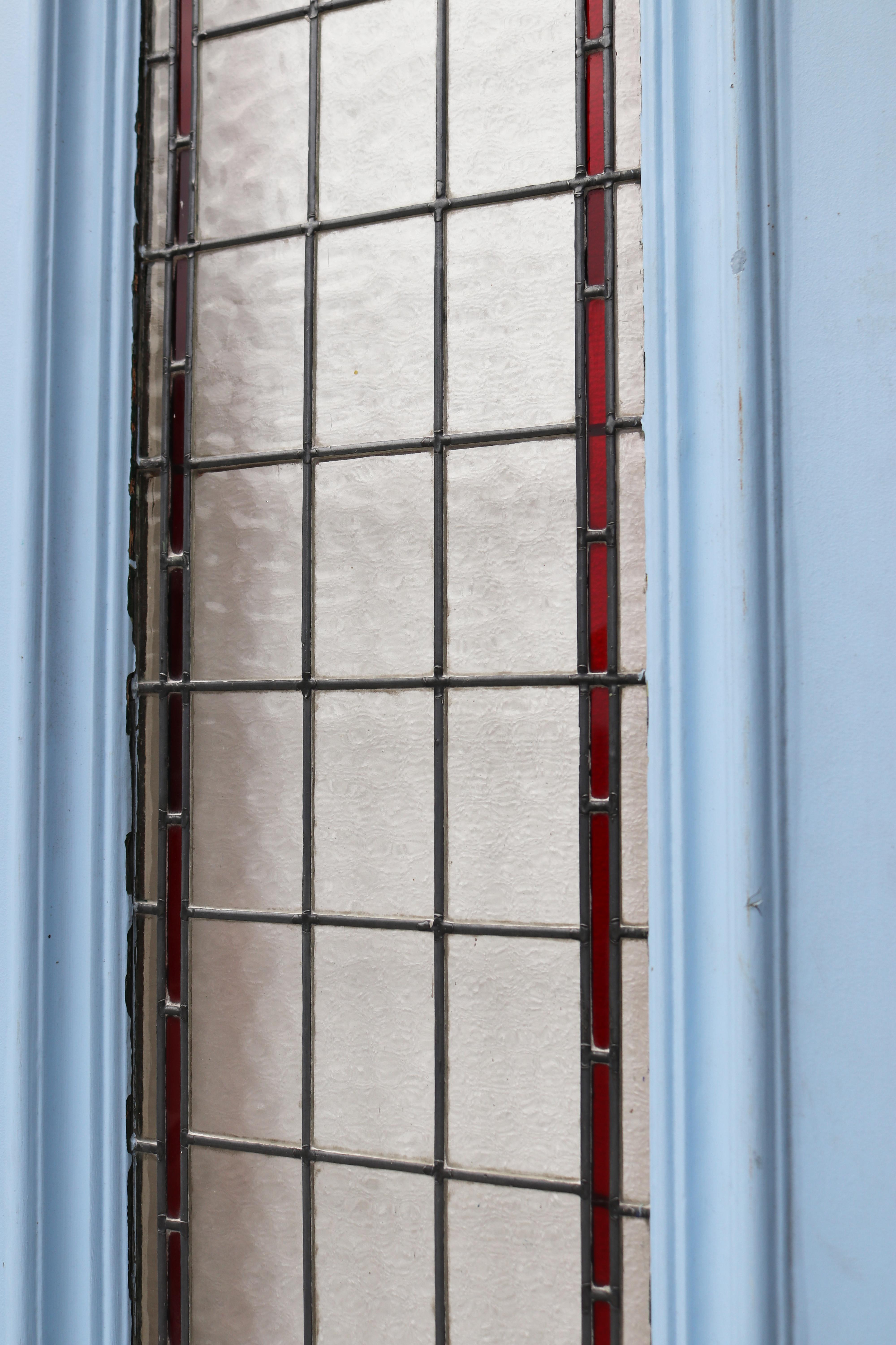 A very large and heavy exterior door with newly re-built stained glass.