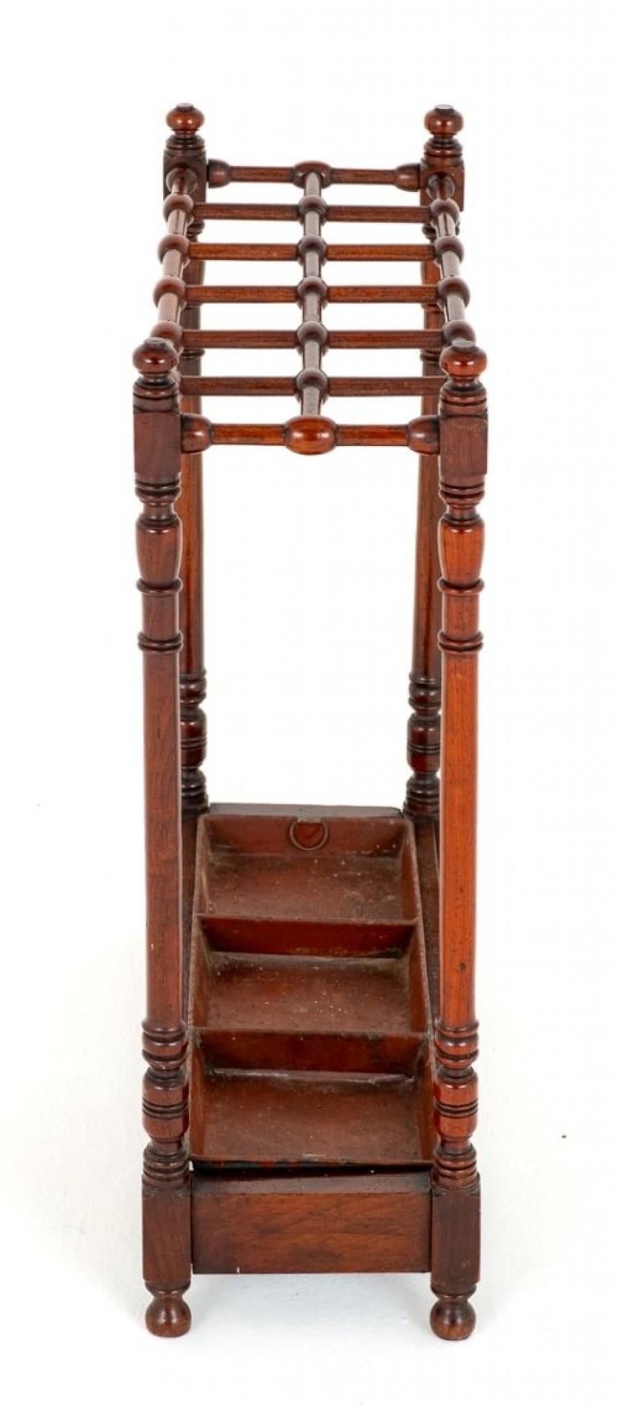 Unusual Victorian mahogany Stick Stand.
Circa 1860
This Stick Stand Features Turned Supports and an Unusual Turned and Sectioned Top for Retaining Ones Sticks, Umbrellas Etc.
Comes Complete with Metal Drip Tray.
Presented in Good Condition