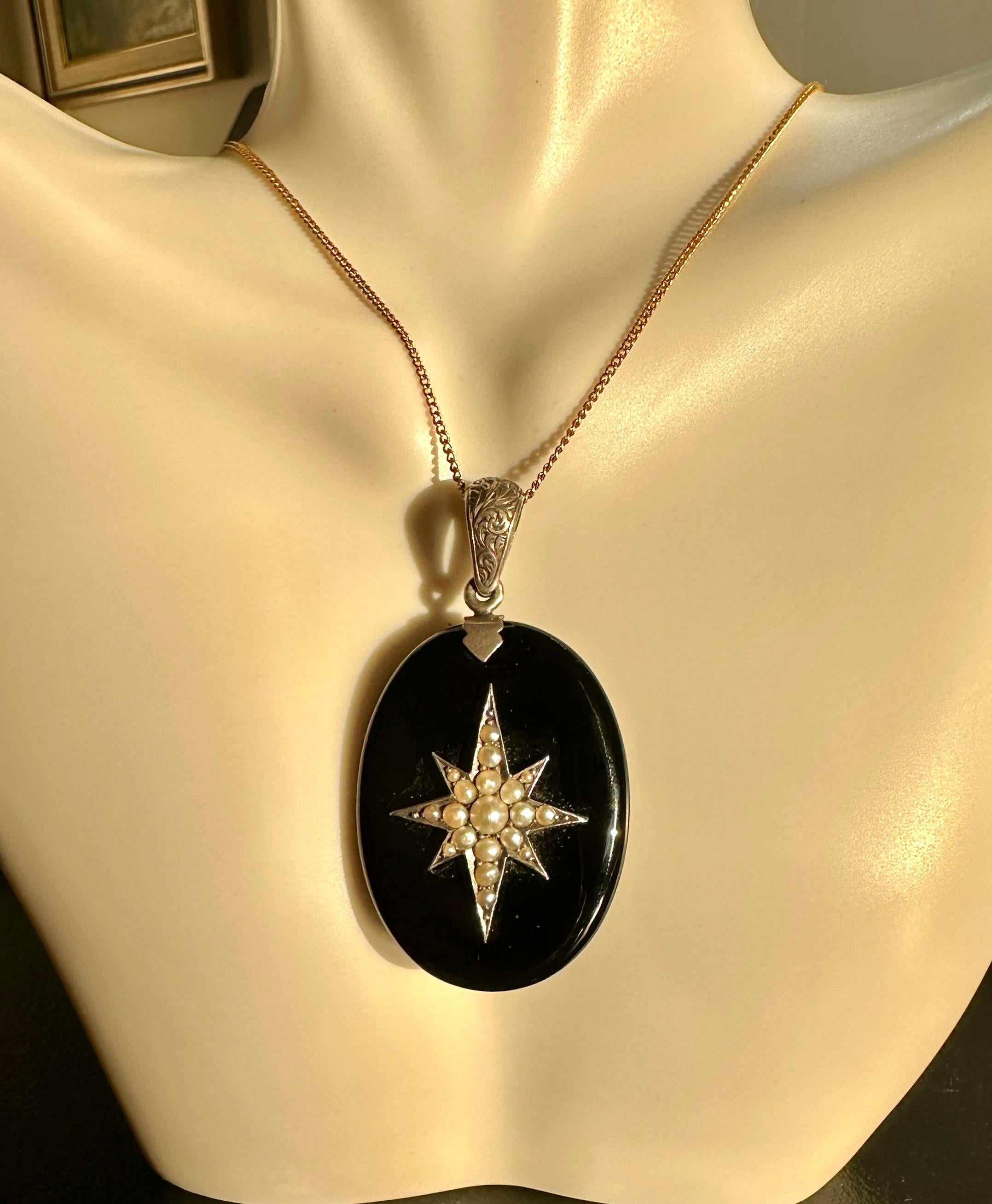 This is a magnificent Antique Victorian to Art Deco Locket Pendant in Black Onyx with an exquisite Pearl set Star Motif on the Black Onyx.   The elegant early locket is silver with a wonderful engraved bale and silver star.  The picture locket is