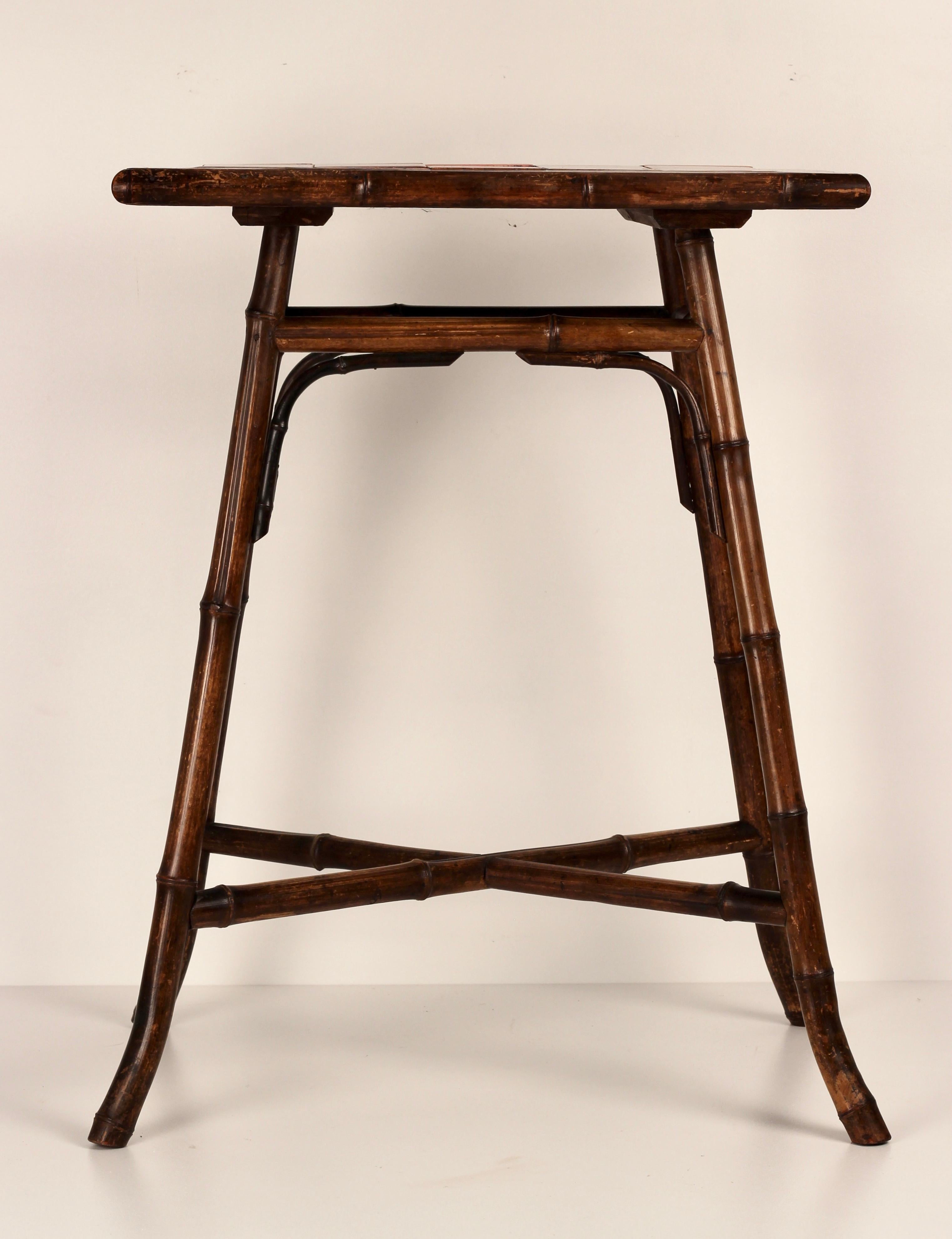 A late Victorian steam bent Bamboo side table with deep red ceramic tiles. This craftsman produced table with its simple, classic lines would also play well in a boho chic contemporary interior.

General note: Shipping quotes as supplied by 1stdibs