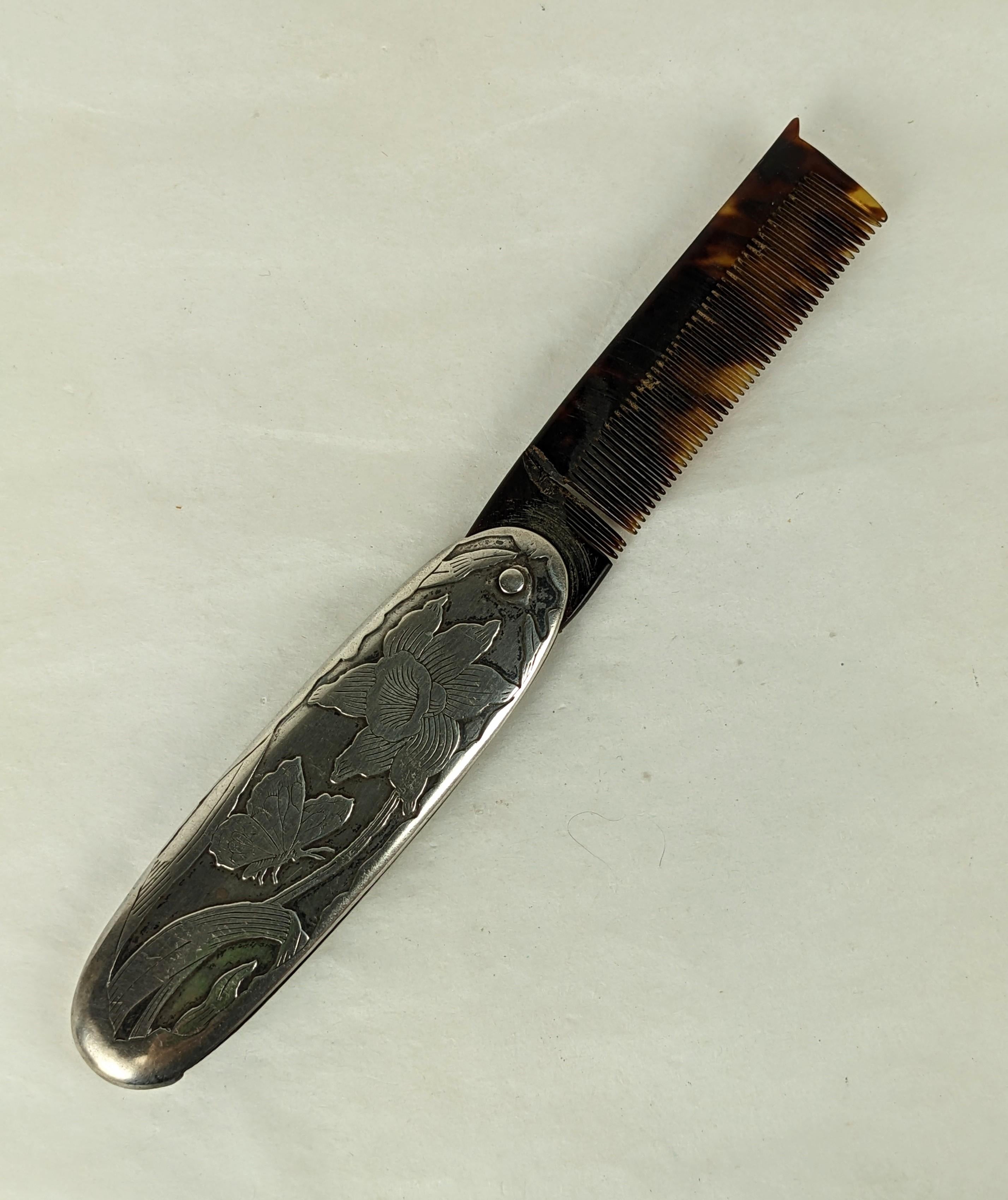 Unusual Victorian Sterling Beard comb from the late 19th Century. Sterling frame hand etched with an iris and butterfly motif. Comb has a break but there is a metal rod inserted within for stability. 
1880's USA. Marked Sterling with Clover