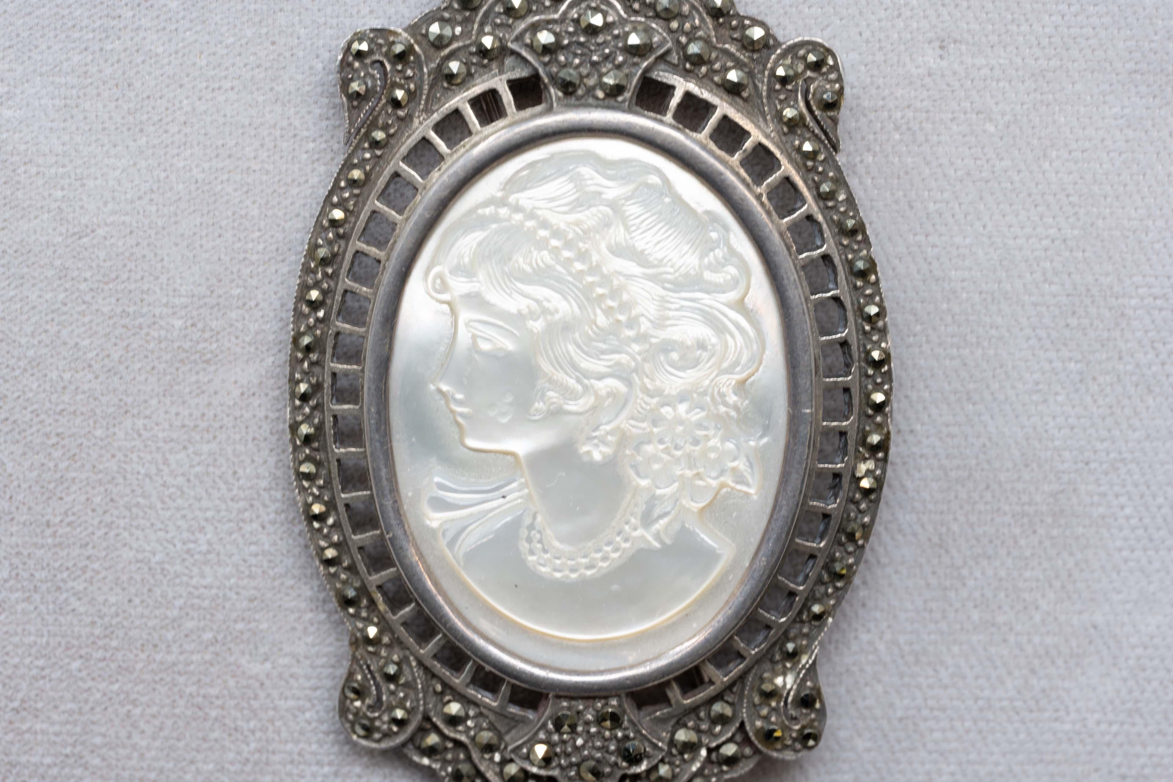Victorian sterling silver brooch pendant with marcasite and carved lady's figure. Stamped 925 on the back, measures 3 inches long x 1 3/4 inches wide. The carving measures 1 1/2 inches x 1 1/3 inches, very good condition. Made in Canada late 19th