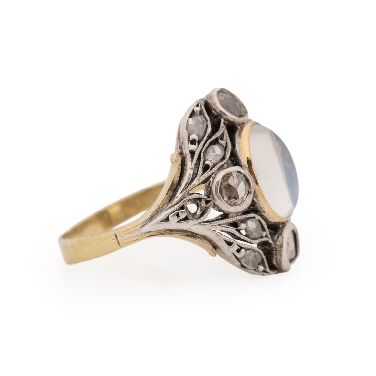 This flora inspired beauty is an excellent example of the Victorian era. Crafted in 18K yellow gold and sterling silver for the two tone look this piece is in great condition considering its age. The shanks are yellow gold, splitting at the top to