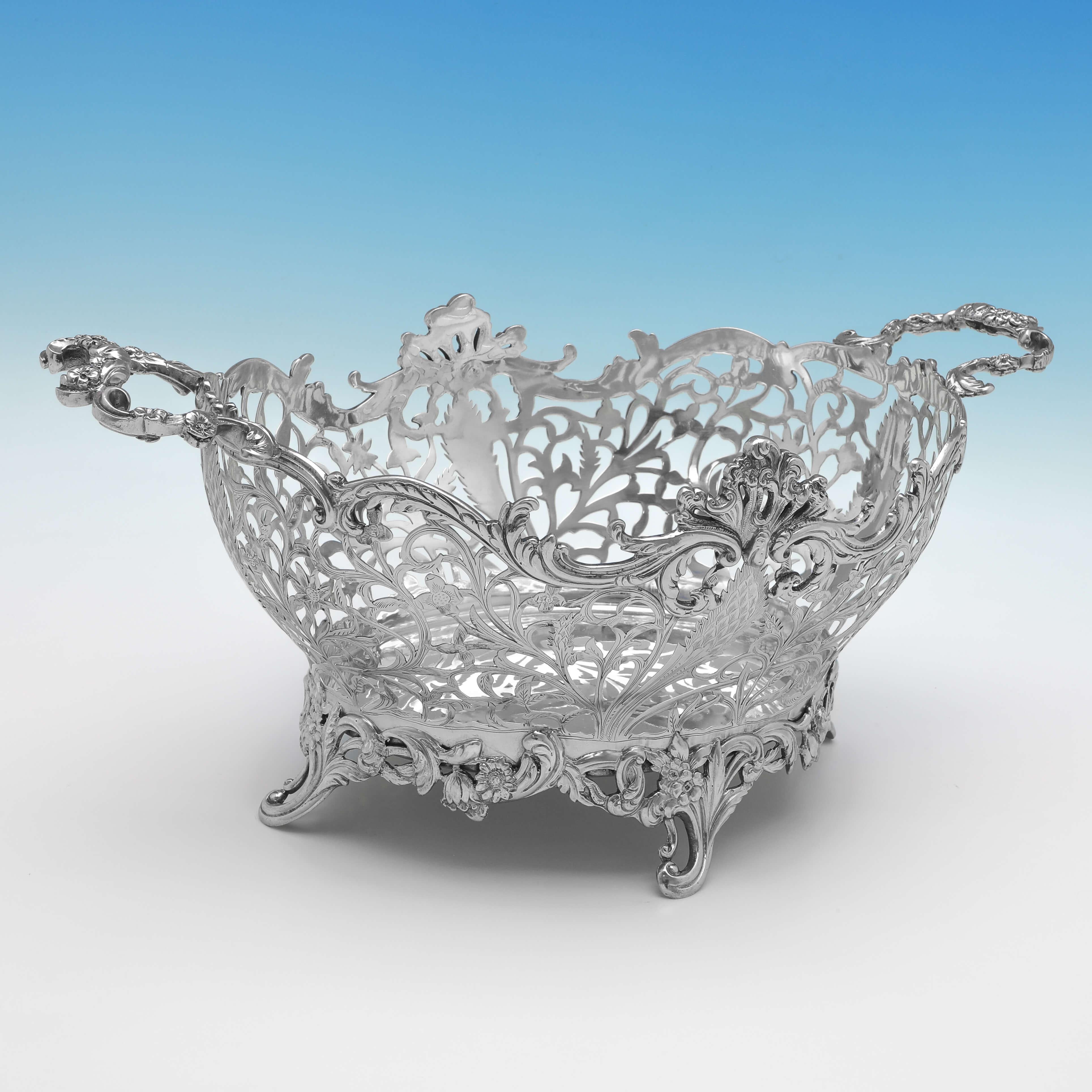 Hallmarked in London in 1899 by William Comyns, this wonderful, Victorian, Antique Sterling Silver Bread Dish, stands on cast feet, and features pierced and engraved decoration around the sides, and floral detailed handles. 

The bread dish