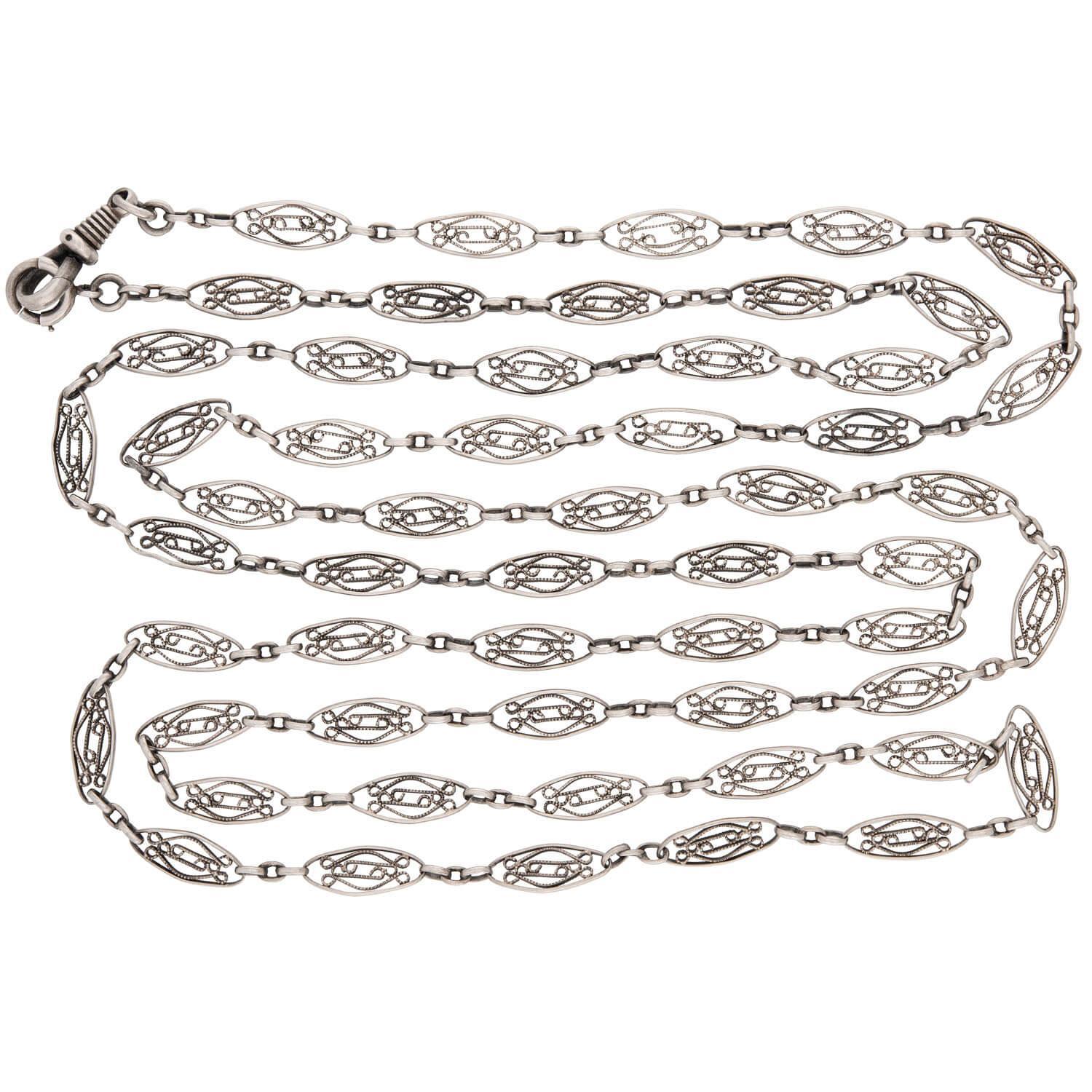 A beautiful chain necklace from the Victorian (ca1880s) era! Crafted in sterling silver, this chain is composed of ellipse-shaped links, which are interiorly decorated with scrolling-motif wirework. The ornate links are connected to one another by