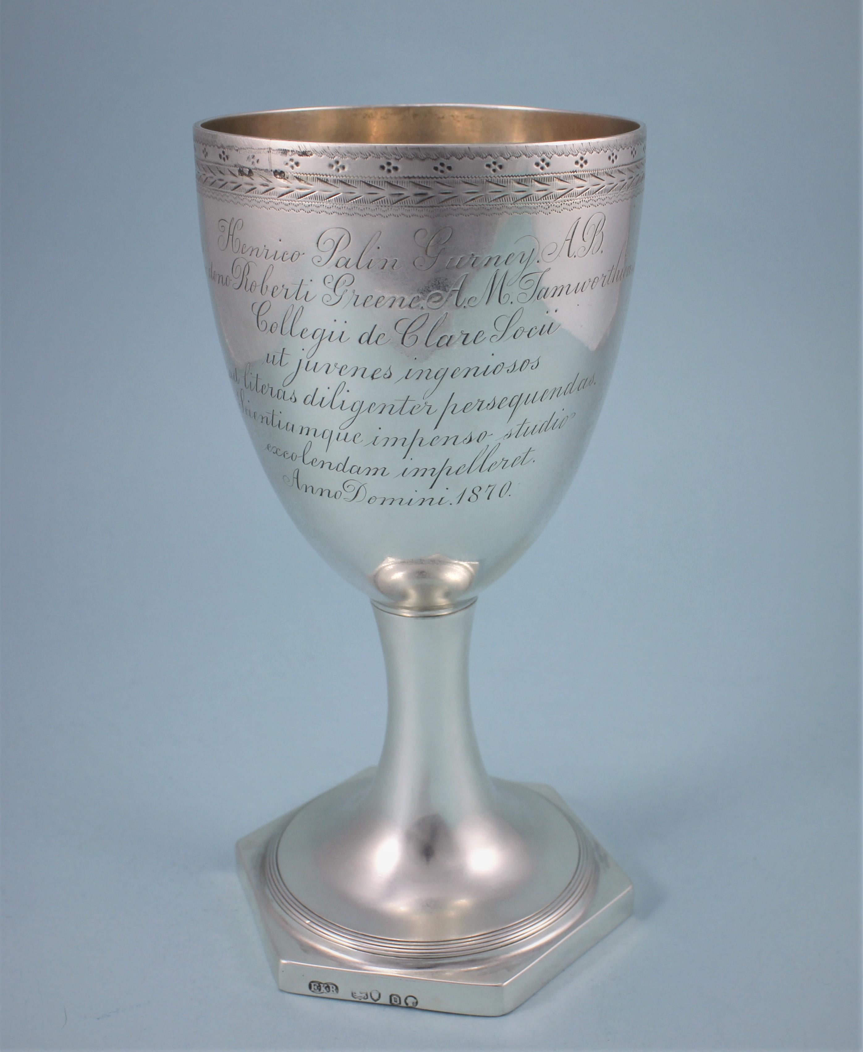 Beautifully executed Victorian sterling silver cup on reeded hexagonal foot.
Maker: E K R. Edward Ker Reid. London, 1869
The rim of the cup has bands of bright cut engraving and the coat of arms below is surrounded by bright cut decoration. The