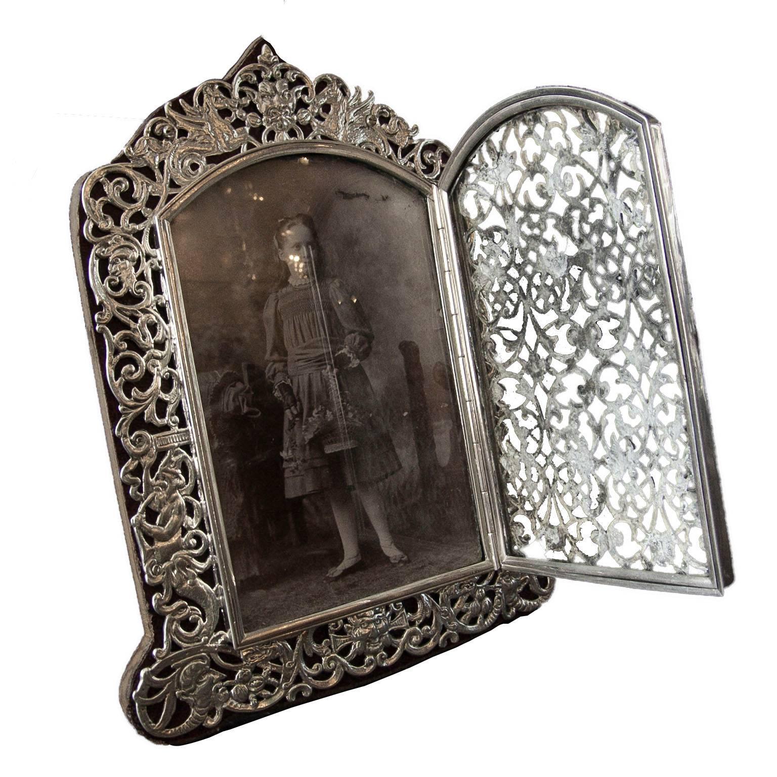 A very rare Victorian sterling silver wonderfully high quality photograph frame with opening aperture and very finely pierced decoration by Judah Rosenthal & Samuel Jacob, London (worked circa 1865-1890).

A decoratively hand pierced silver