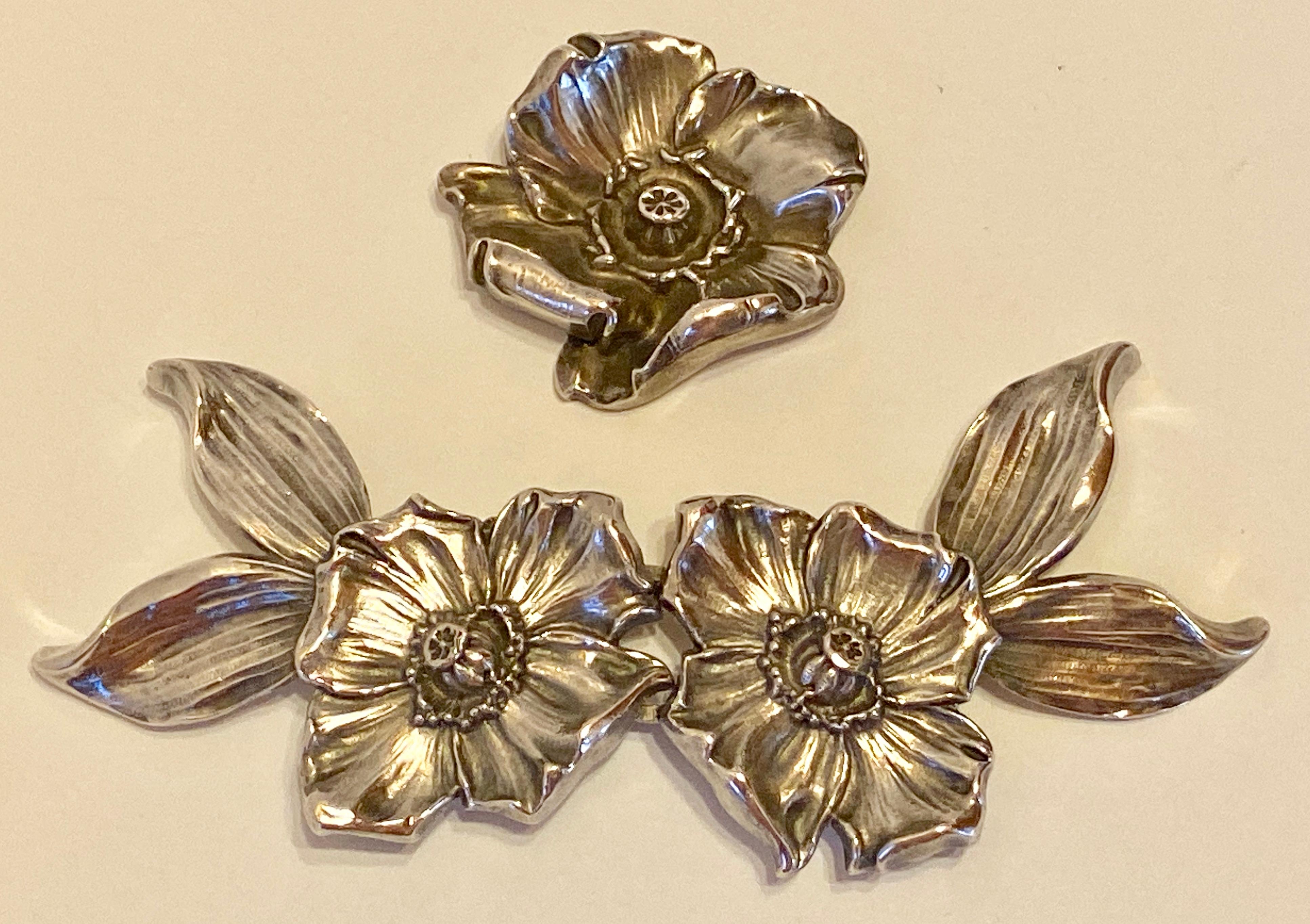      This wonderfully detailed Victorian sterling silver floral 2-Piece belt buckle with a matching floral sterling silver brooch. The 2-piece floral belt buckle measures 5 inches in length (when put together), 2 inches in width (or height), and 1/2