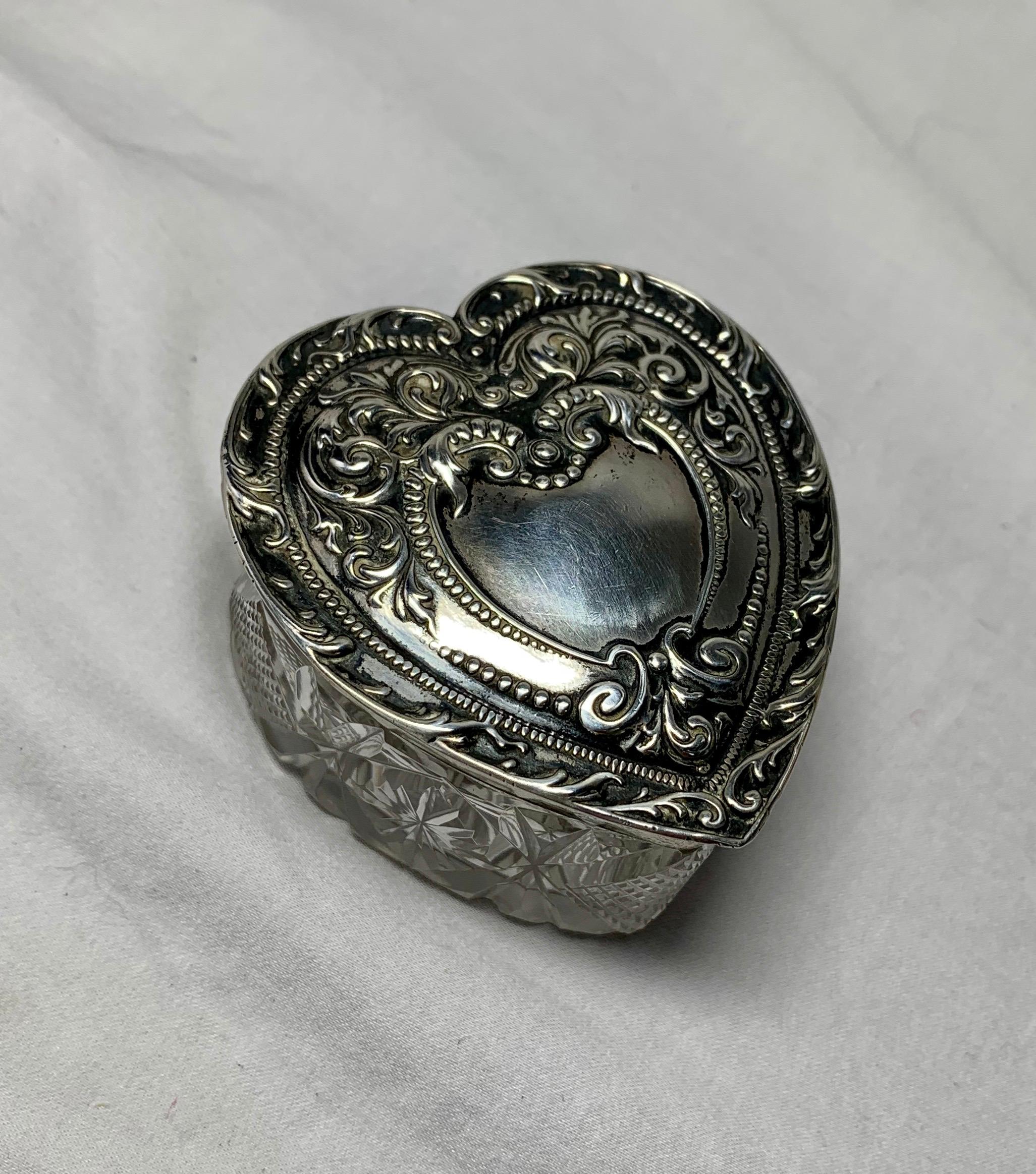 THIS IS A WONDERFUL ANTIQUE VICTORIAN HEART SHAPE BOX WITH A STERLING SILVER REPOUSSE ENGRAVED TOP OF EXTRAORDINARY BEAUTY WITH A CRYSTAL BOTTOM.   THE SILVER JEWELRY, KEEPSAKE, DRESSER, PATCH BOX HAS AN ACANTHUS SCROLL MOTIF REPOUSSE DESIGN WITH