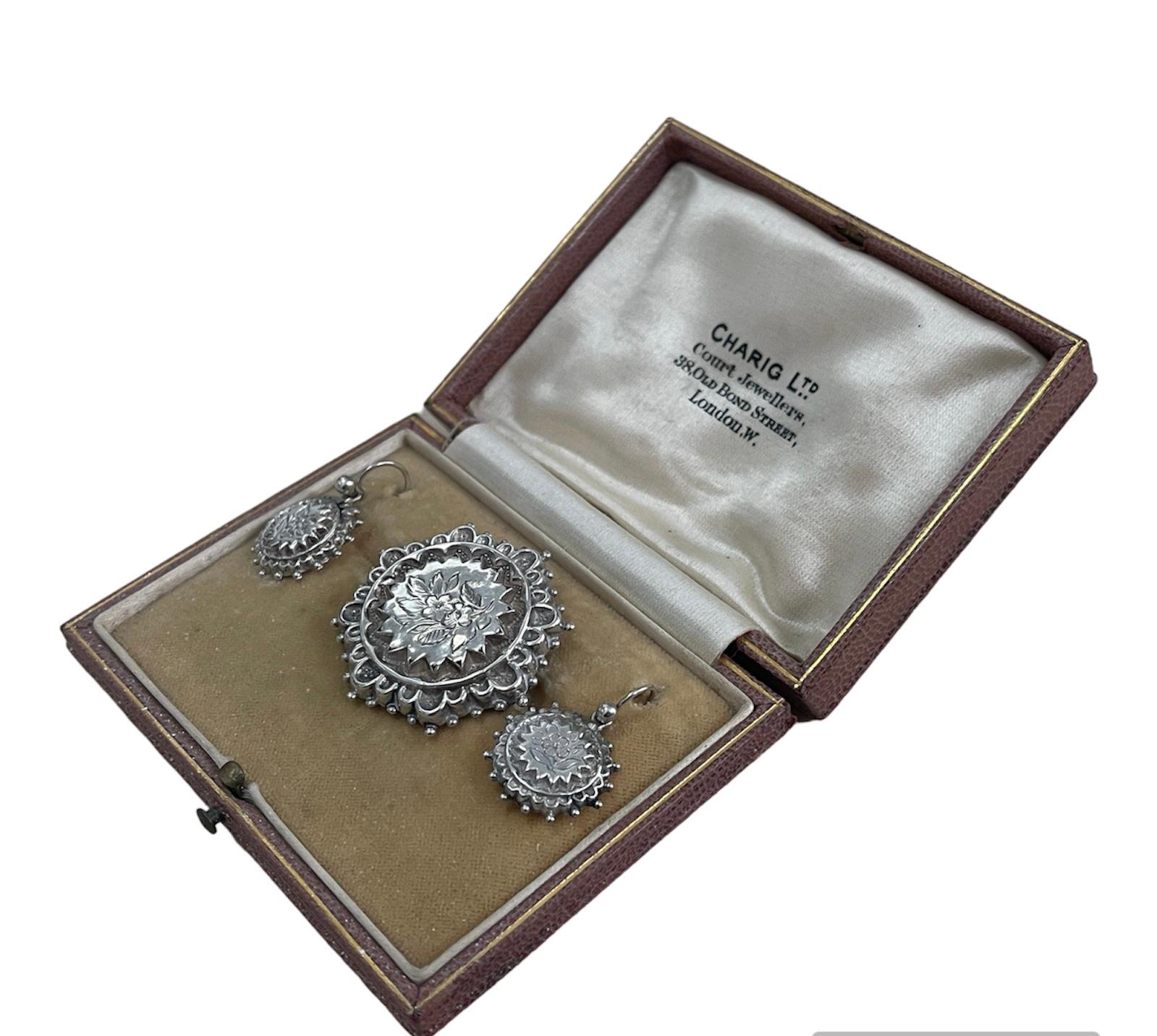 This lovely Victorian demi-parure features floral, hand etched decoration with a romantic edge.  The brooch hides a secret photo frame on the reverse which can hold your loved one close to your heart.
The matching earrings sit elegantly at the base