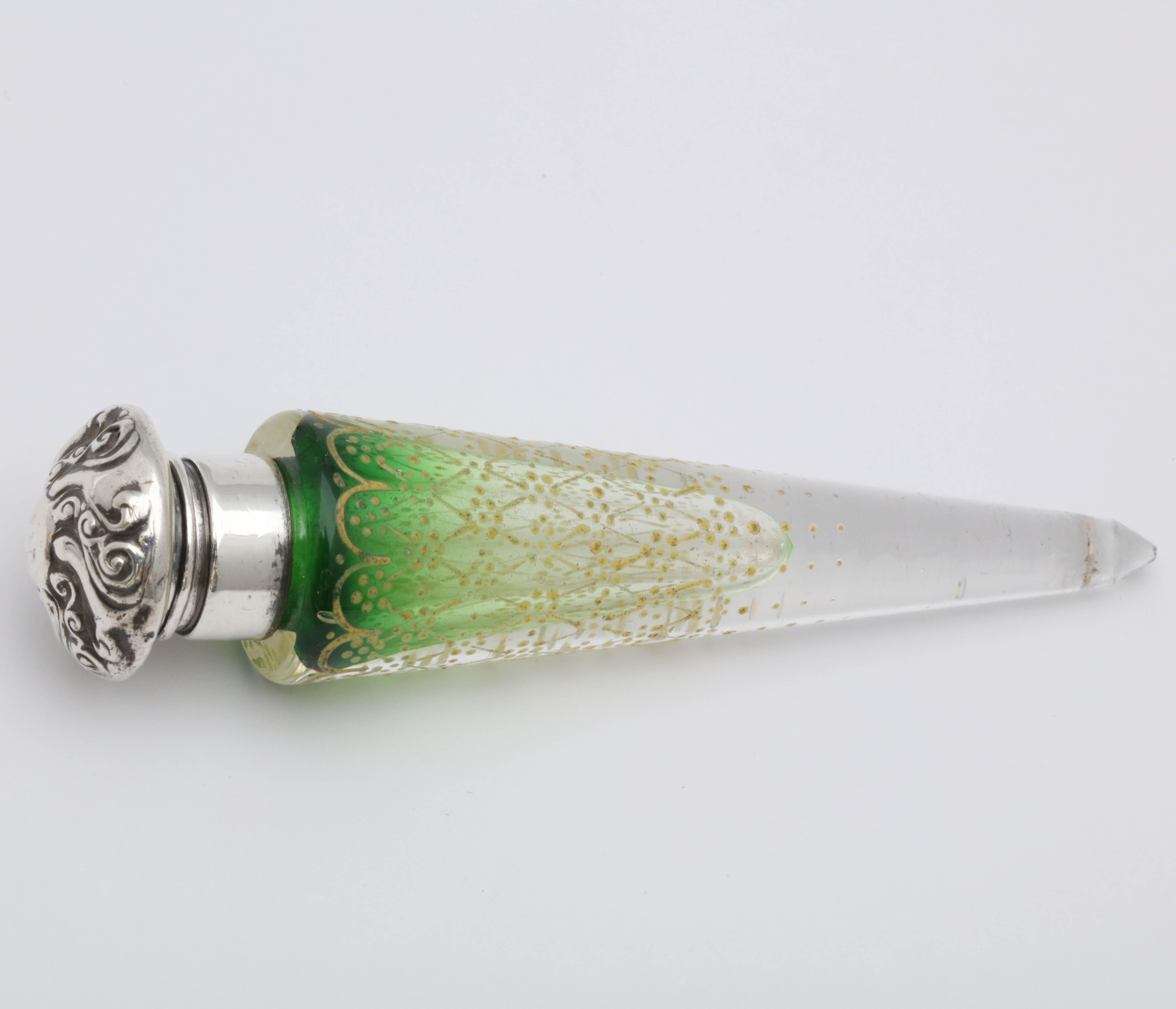 Beautiful, sterling silver-mounted, gold enameled, green crystal, lay-down perfume bottle, Woodside Silver Co., New York, Ca. 1896. Measures 4 3/4 inches long x 1 inch wide at widest point. Color of green crystal graduates from dark green to clear.