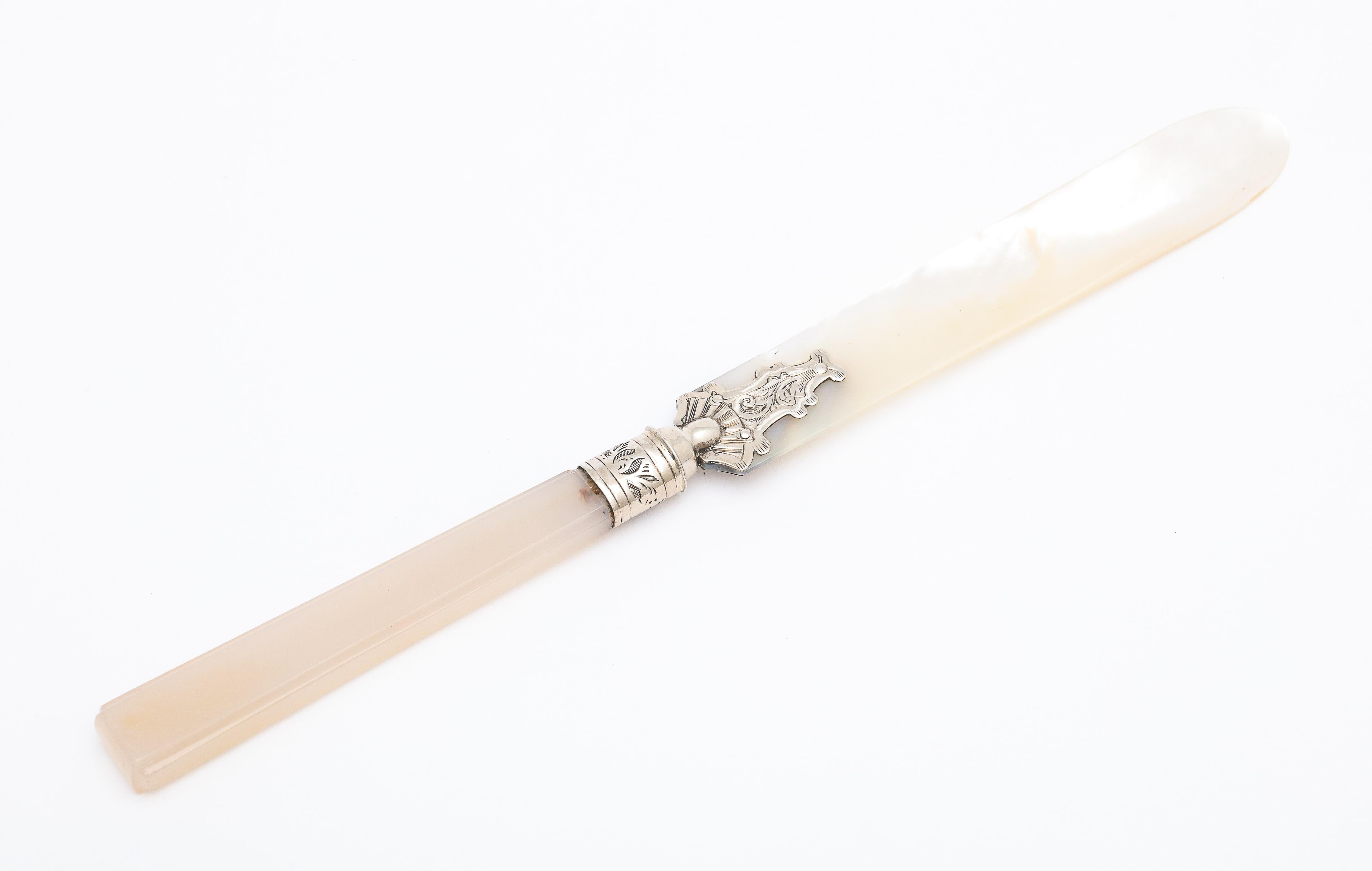 Victorian, sterling silver (unmarked but tested) - mounted mother of pearl and chalcedony letter opener/paper knife, England, circa 1890s. Sterling silver mount is etched; edges of chalcedony handle are beveled. Mother of pearl shimmers in the