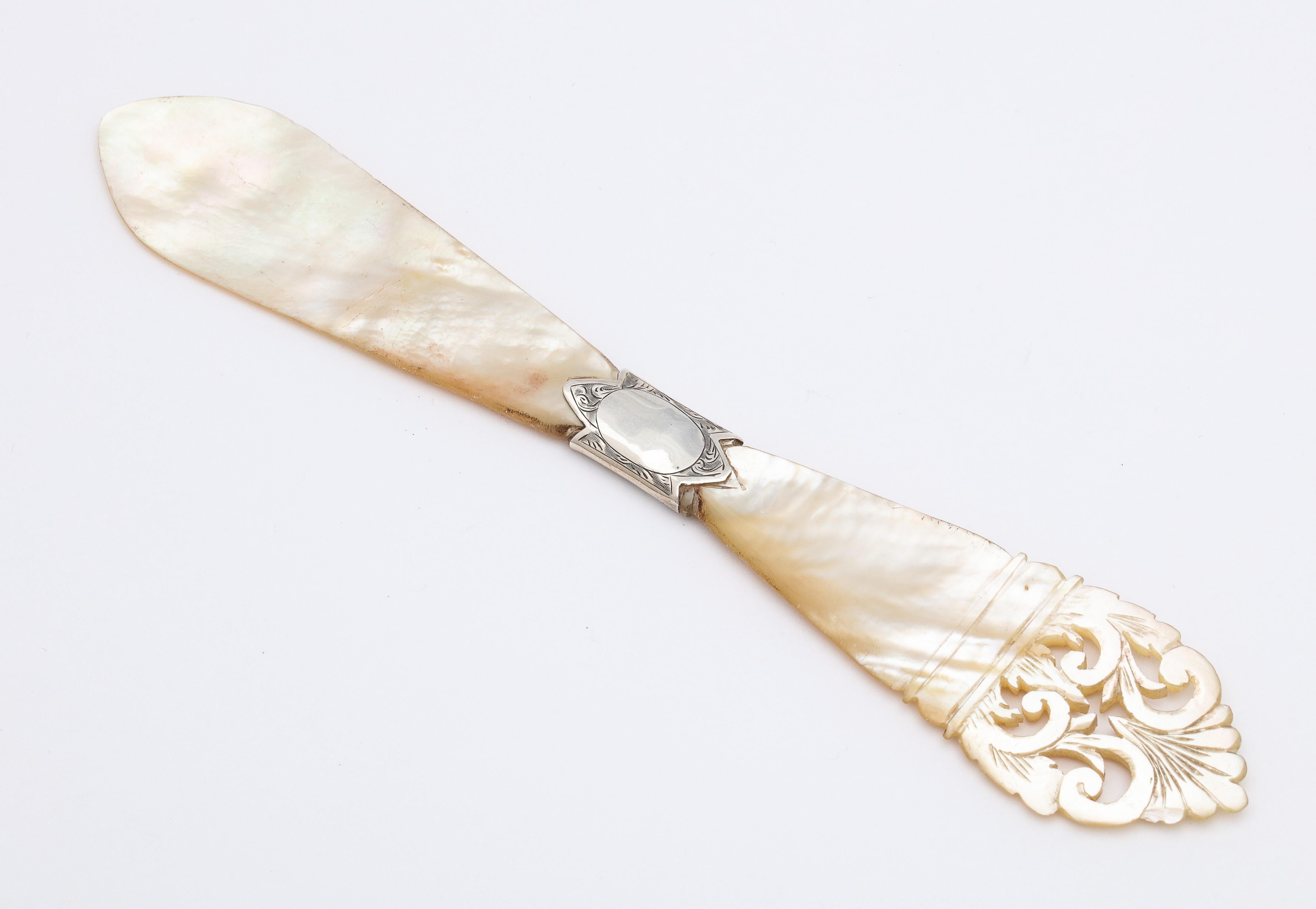 Victorian, sterling silver-mounted mother of pearl letter opener, Birmingham, England, William Warr - maker. Lovely etching on sterling silver mount. Lower portion of mother of pearl handle is pierced in design. Mother of pearl shimmers in the