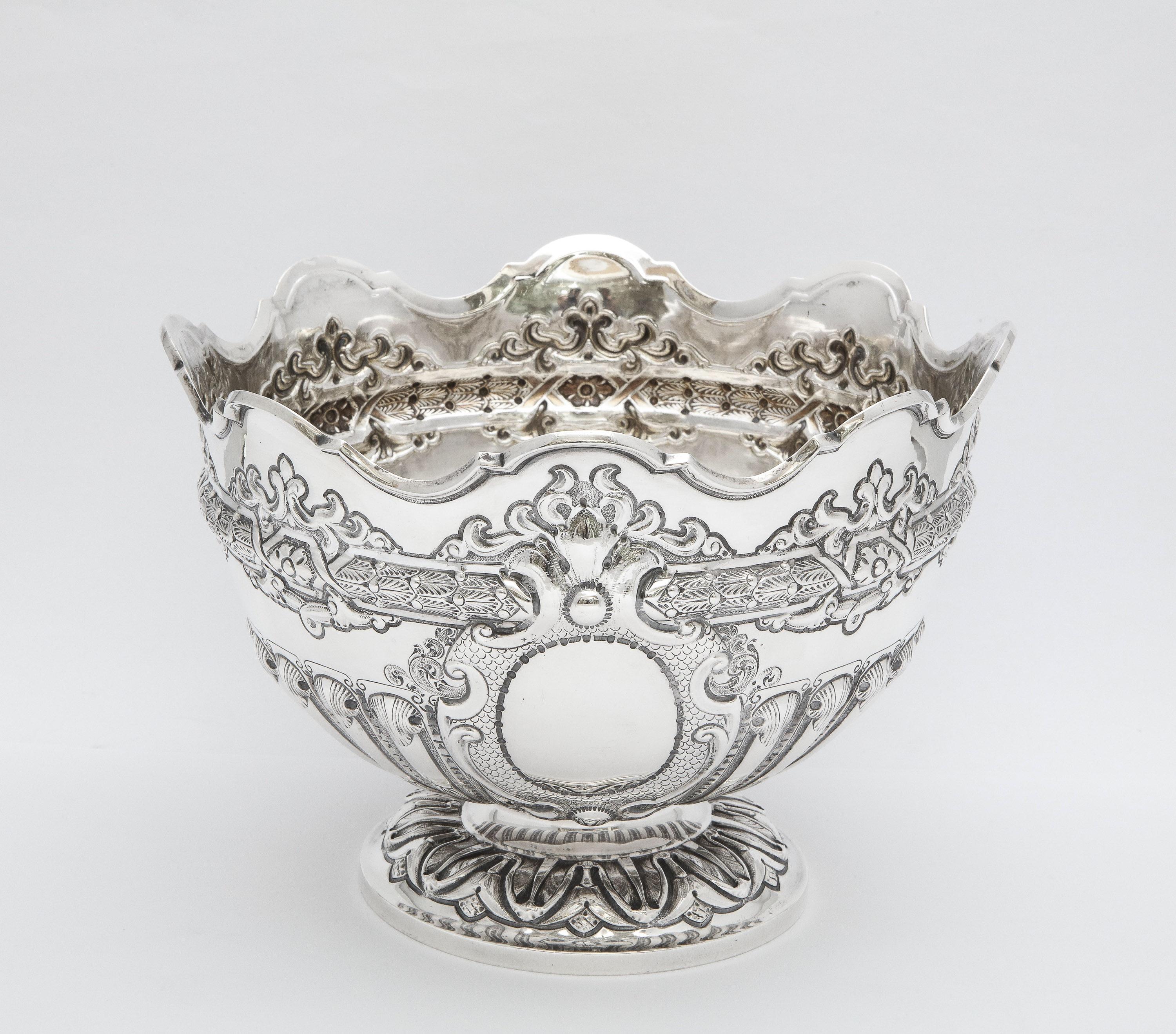 Victorian, sterling silver, pedestal-based Monteith/centerpiece bowl, London, year-hallmarked for 1898, Joseph Hicks - maker. Measures 6 inches high x 8 1/4 inches diameter. Weighs 19.830 troy ounces. Vacant cartouche. Lovely decoration. Dark areas