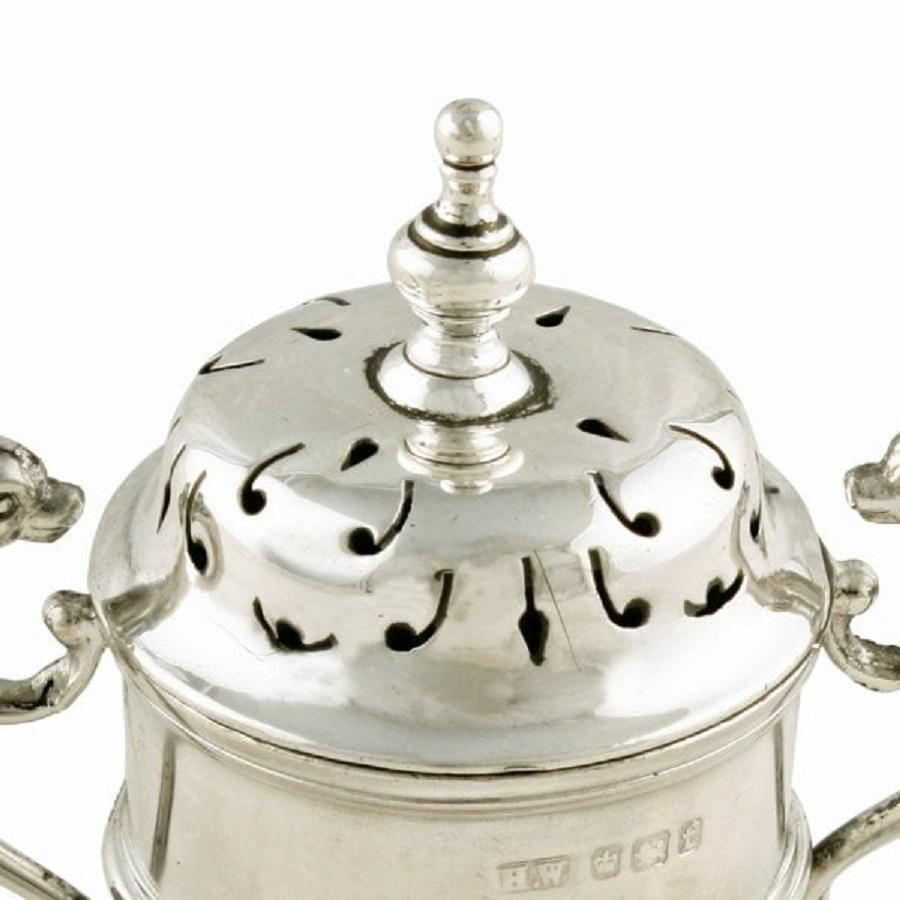 A late 19th century Victorian sterling silver trophy shaped pepper pot.

The pepper pot has hall marks Sheffield, the year 1898 and the maker's mark for Henry Wigfull.

The pot has a finial to the top and a pair of shaped handles with dolphin