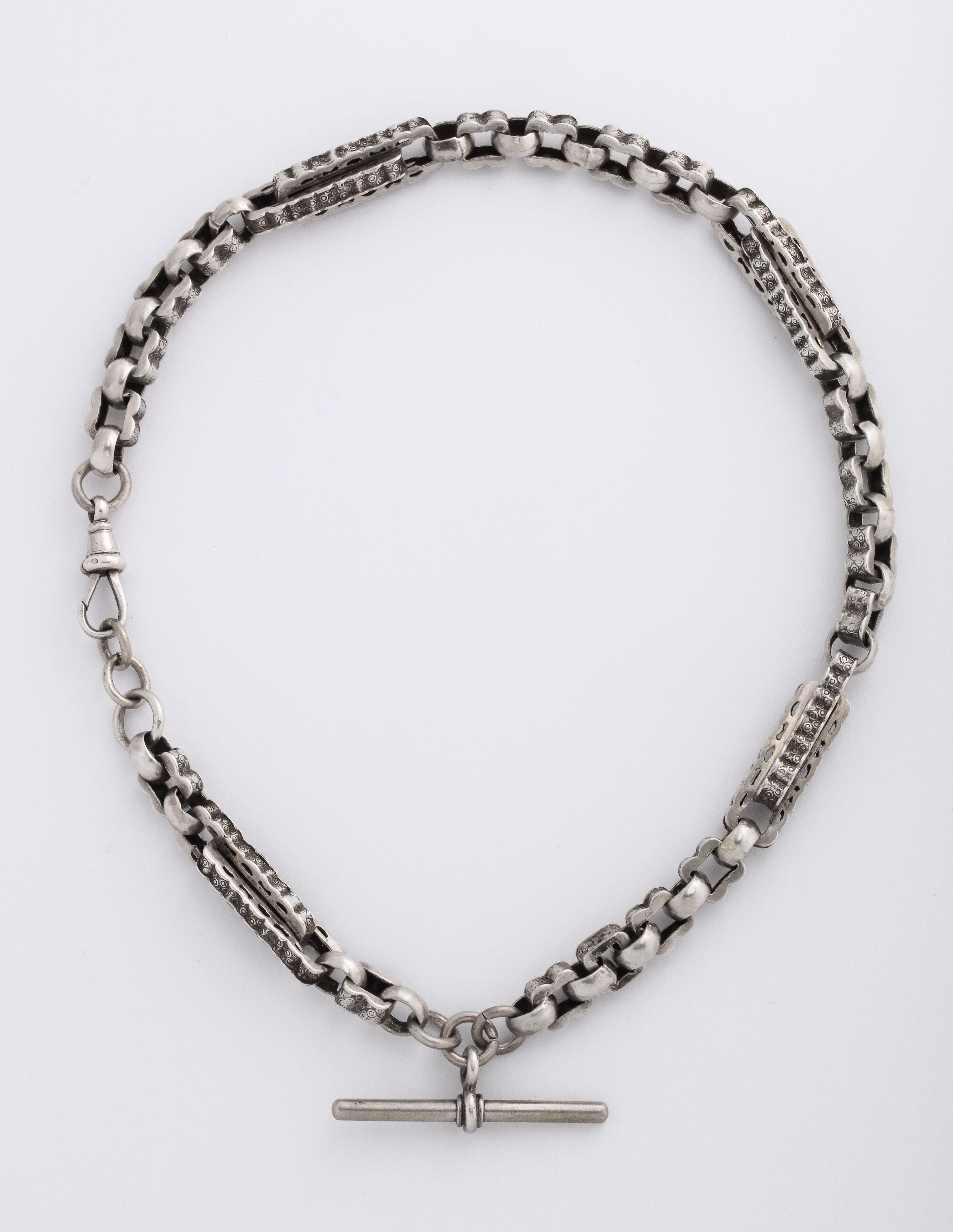 Victorian Prince Albert Chain in Sterling has interesting links that vary in size and direction. There are wiggly square links, alternating horizontal and vertical links, and large rectangular ridged links with a t bar added. Prince Albert chains
