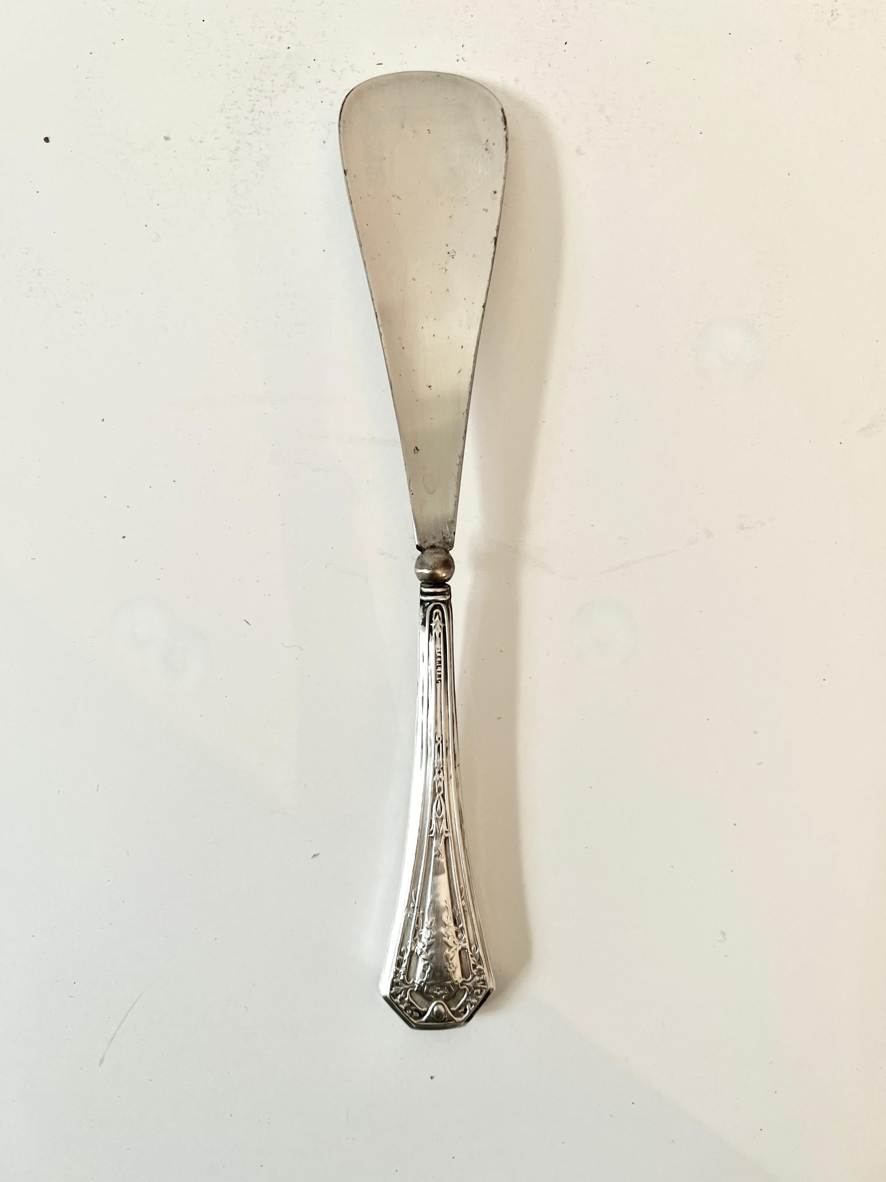 Un impresionante calzador de plata de ley.  ¡Un complemento maravilloso para tu tocador, el armario o el cajón de los calcetines!

Bonita empuñadura de esterlina con una fuerte pieza chapada en metal para usarla a modo de presión mientras te calzas