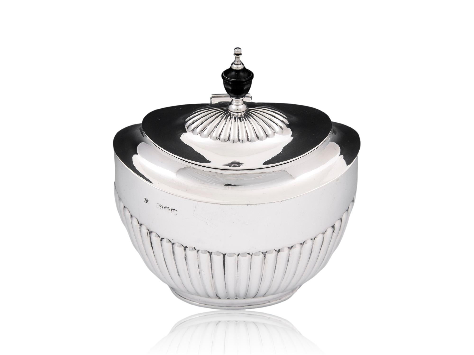 Ebony & Silver Finial 

From our Tea Caddy collection, we are pleased to offer a Victorian Silver Tea Caddy. The Silver Tea Caddy of unusual oval shape with a gadrooned ribbed exterior and stepped lid surmounted by an Ebony and Silver finial. The