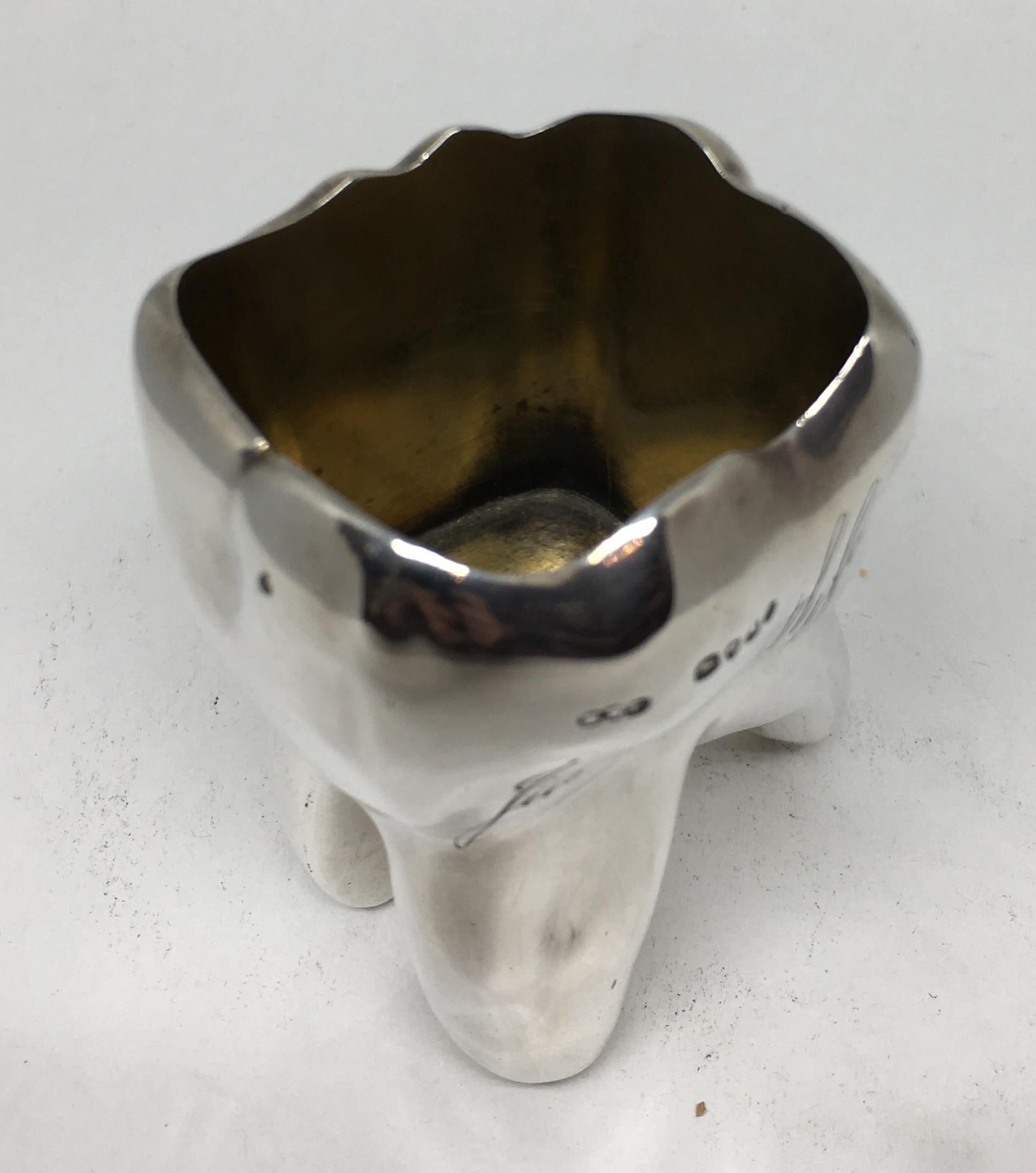 A rare and unusual late Victorian, sterling silver whiskey shot glass fashioned as a tooth.

By Henry William Dee and dated for London, 1883.

The tooth retains some of the original gilding to the inside. Both sides of the tooth are engraved