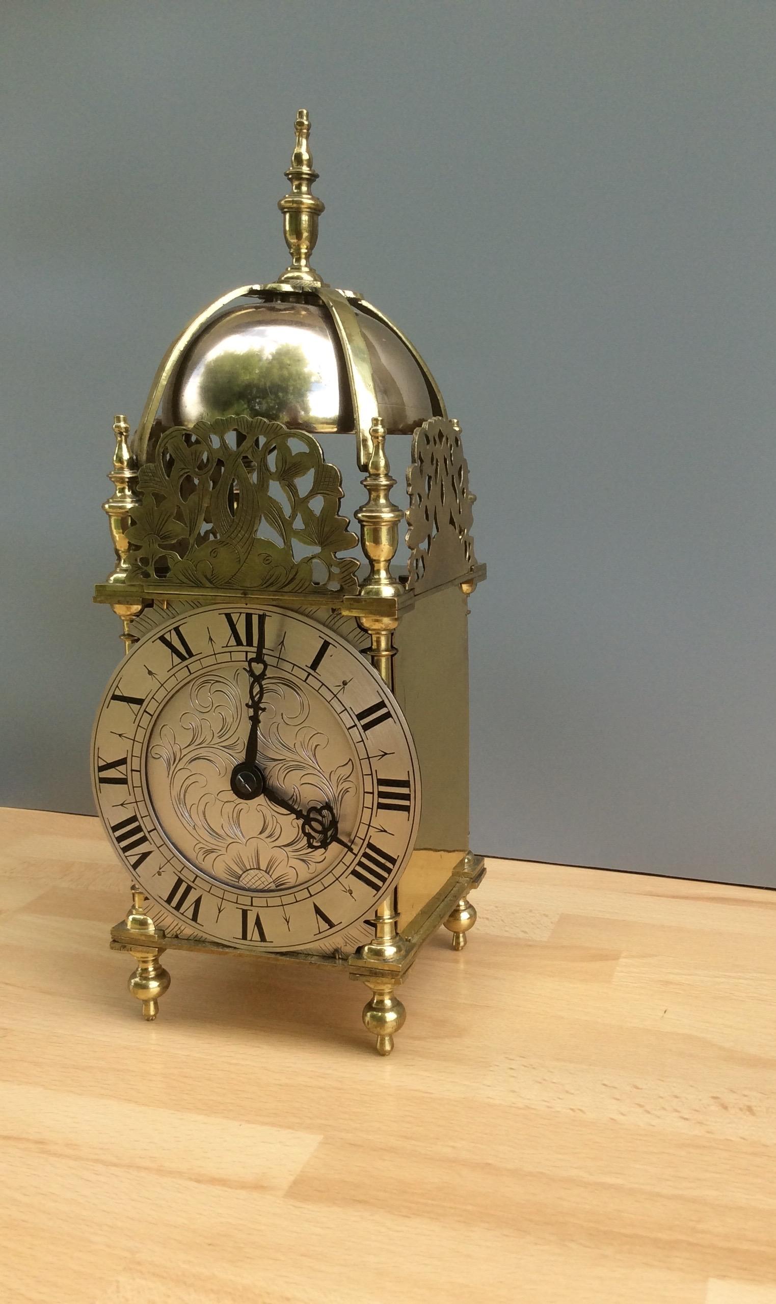 Late Victorian brass lantern clock with silvered dial mask, beautiful engraved and silvered chapter ring with Roman numerals. 8 day French movement striking the hours and halves on a centrally mounted bell, circa 1860.