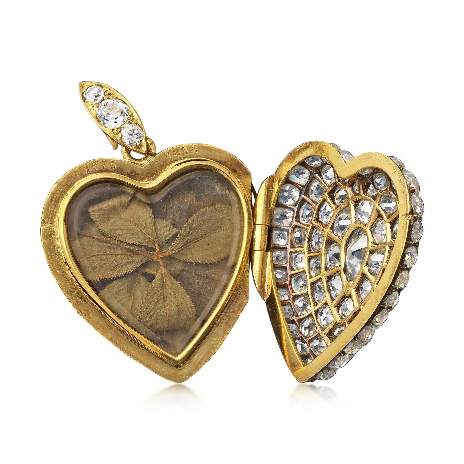 A stunning late Victorian diamond heart shaped pendant locket c.1896, the domed heart fully pavé set to the front with old mine cut diamonds and centred with a single pear shape, all in a pierced out silver setting backed with gold, the rounded back