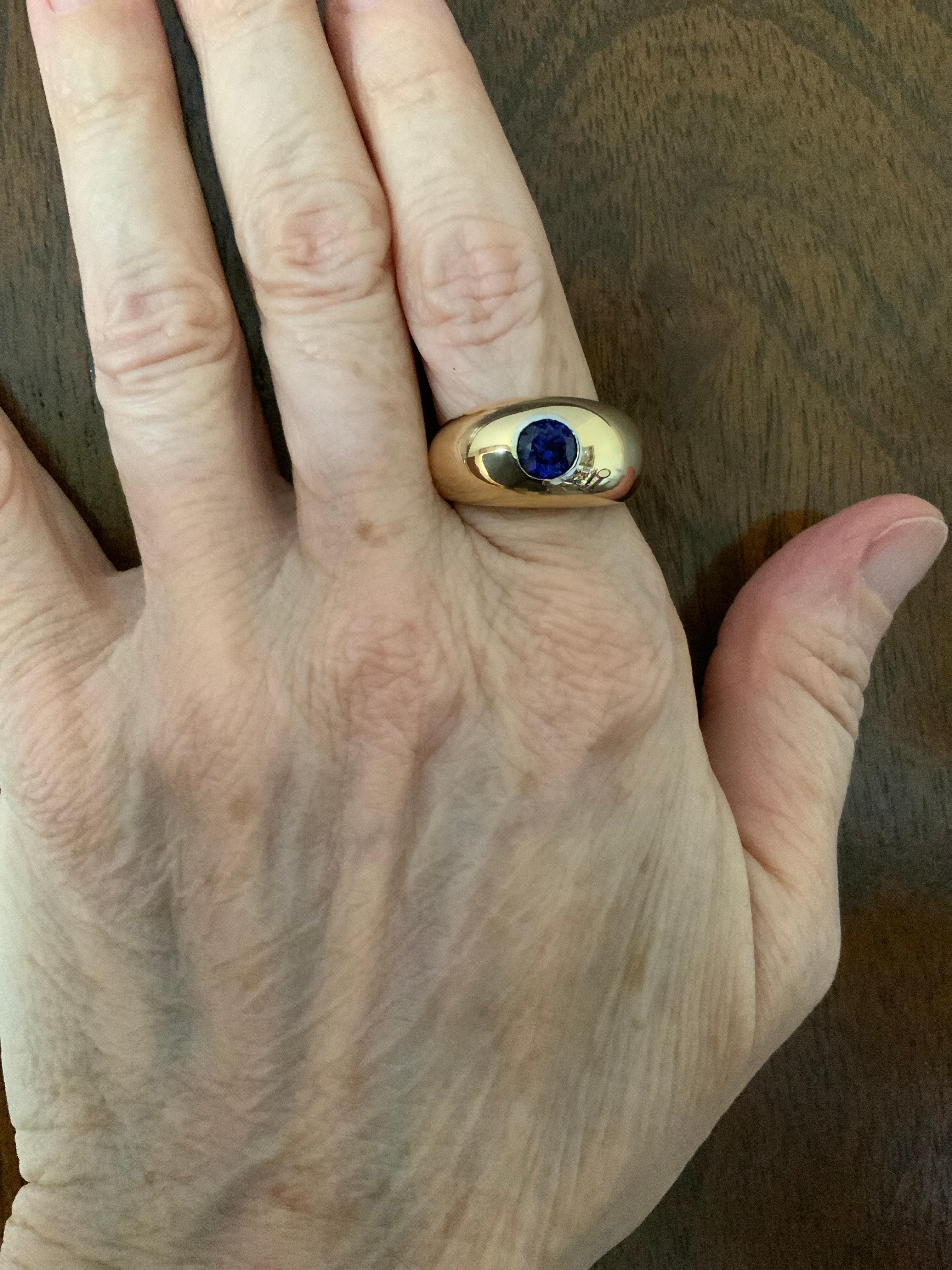 This is a Victorian Style 18K gold Sapphire Gypsy Ring. It depicts a yellow gold ring with a brilliant shape royal blue corundum sapphire in bezel setting in the center supported by wide gold shanks. It measures 6.6 x 6.5 x 3.96 mm and its weight is