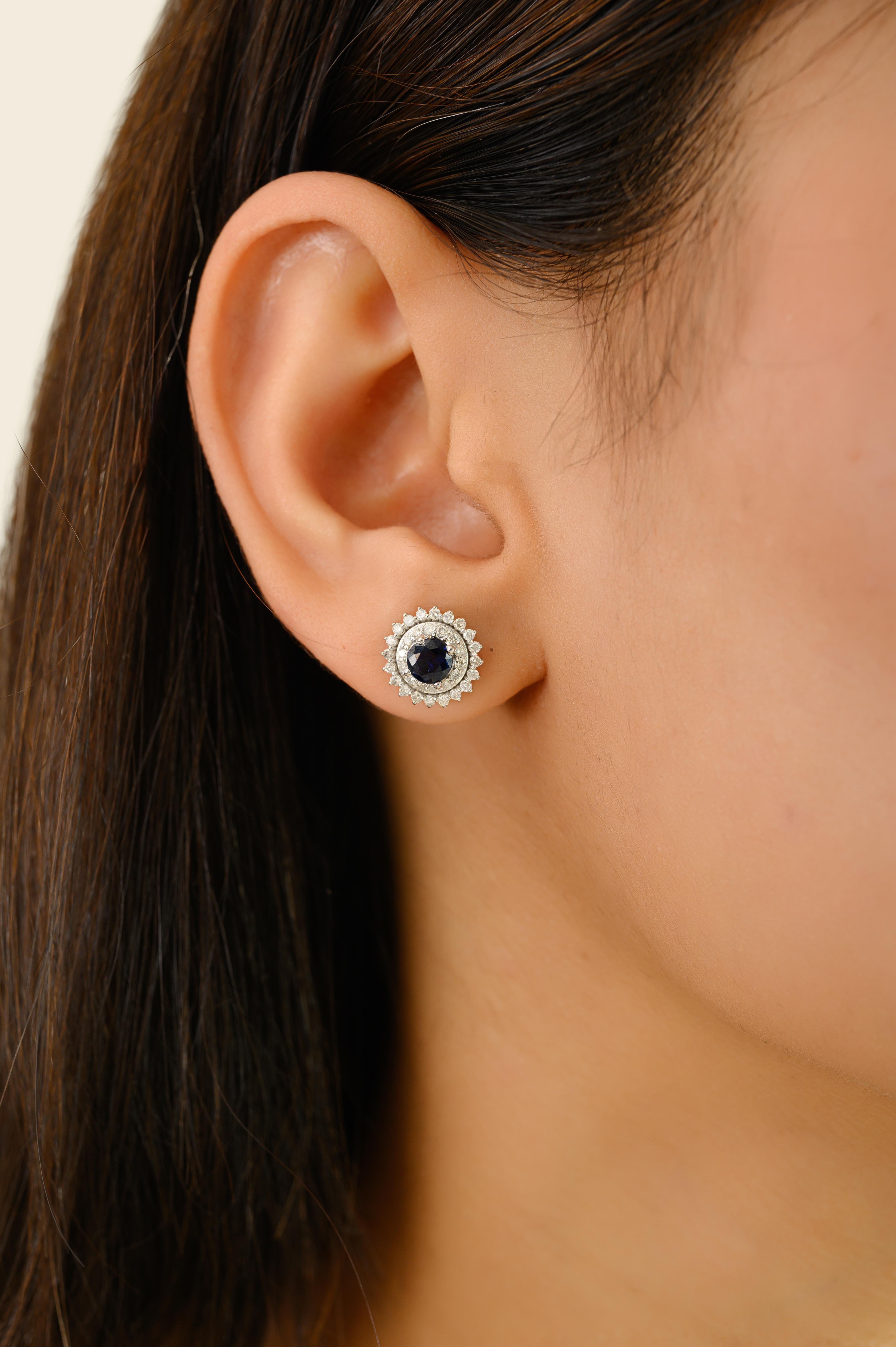 Elegant and timeless, these stunning earrings are crafted in luxurious 18K white gold, showcasing the perfect harmony between classic design and refined brilliance. At the heart of each stud is a rich blue sapphire, totaling 1.2 carats, expertly