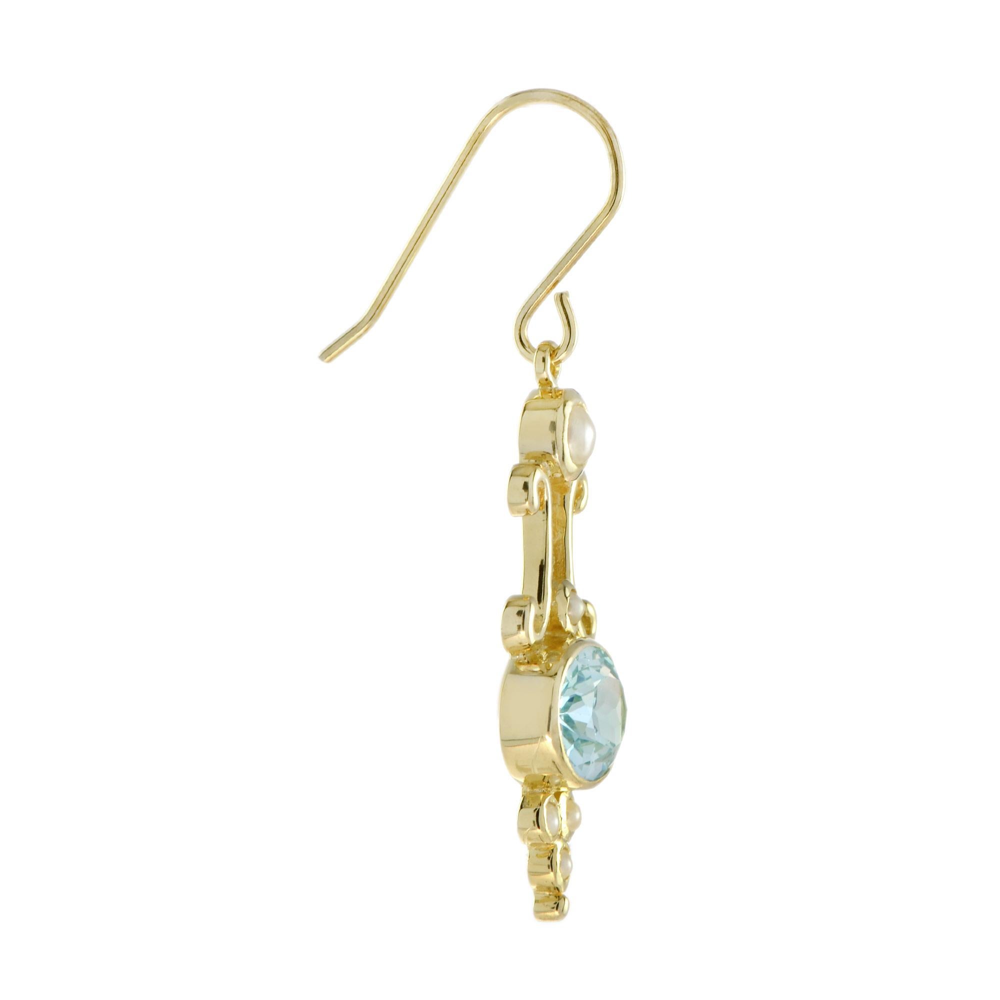 Dainty Victorian design, handcrafted of blue topaz and pearls set into 14k yellow gold, is alluring at any hours of the day or night. 

Information
Metal: 14K Yellow Gold
Width: 11 mm.
Length: 42 mm.
Weight: 4.60 g. (approx. in total)
Backing:
