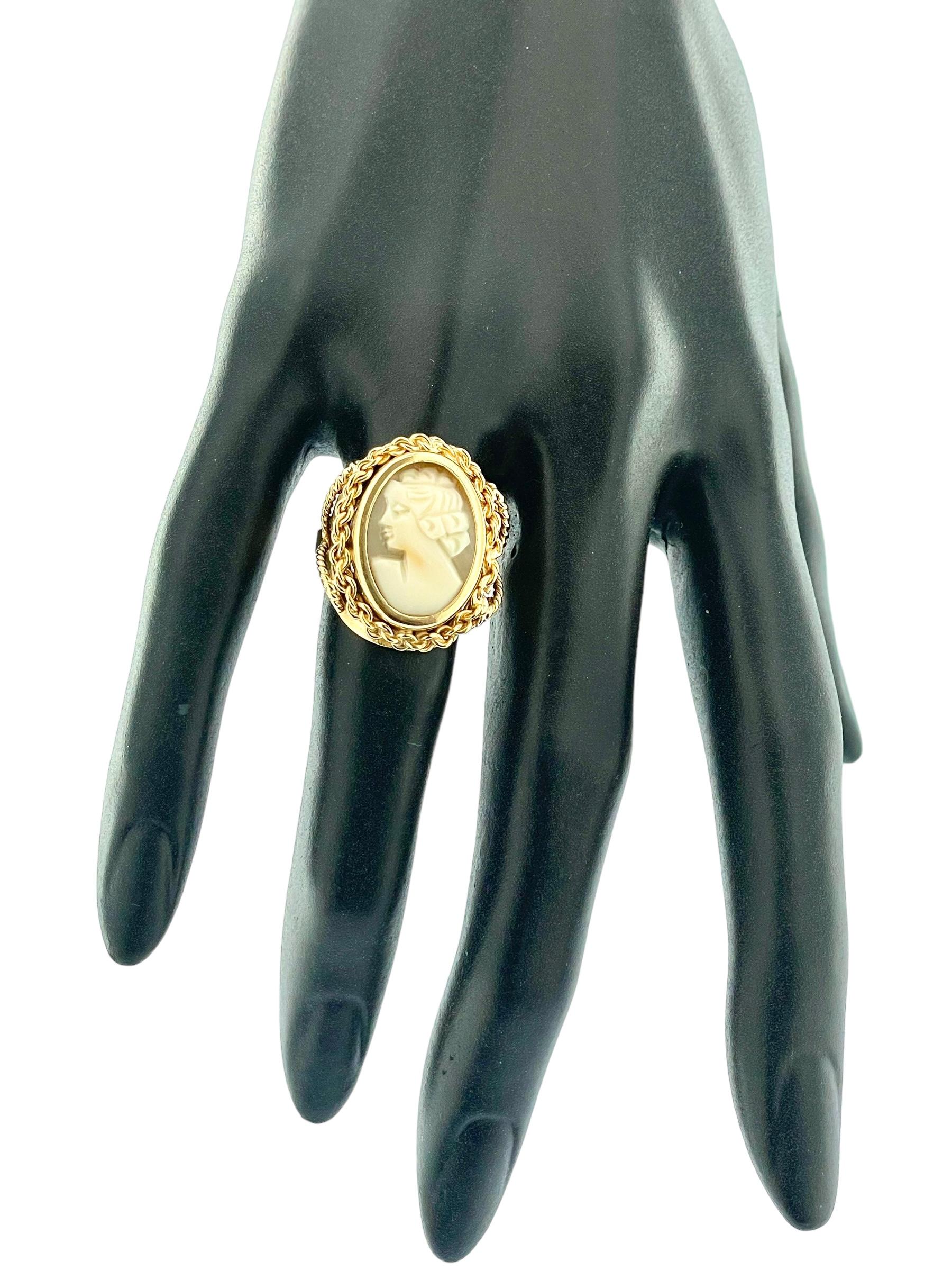 The Victorian Style Cameo Yellow Gold Ring is a beautiful homage to the elegance and sophistication of the Victorian era. This ring, crafted from luxurious 18kt yellow gold, features intricate wire work and a finely detailed shell cameo,