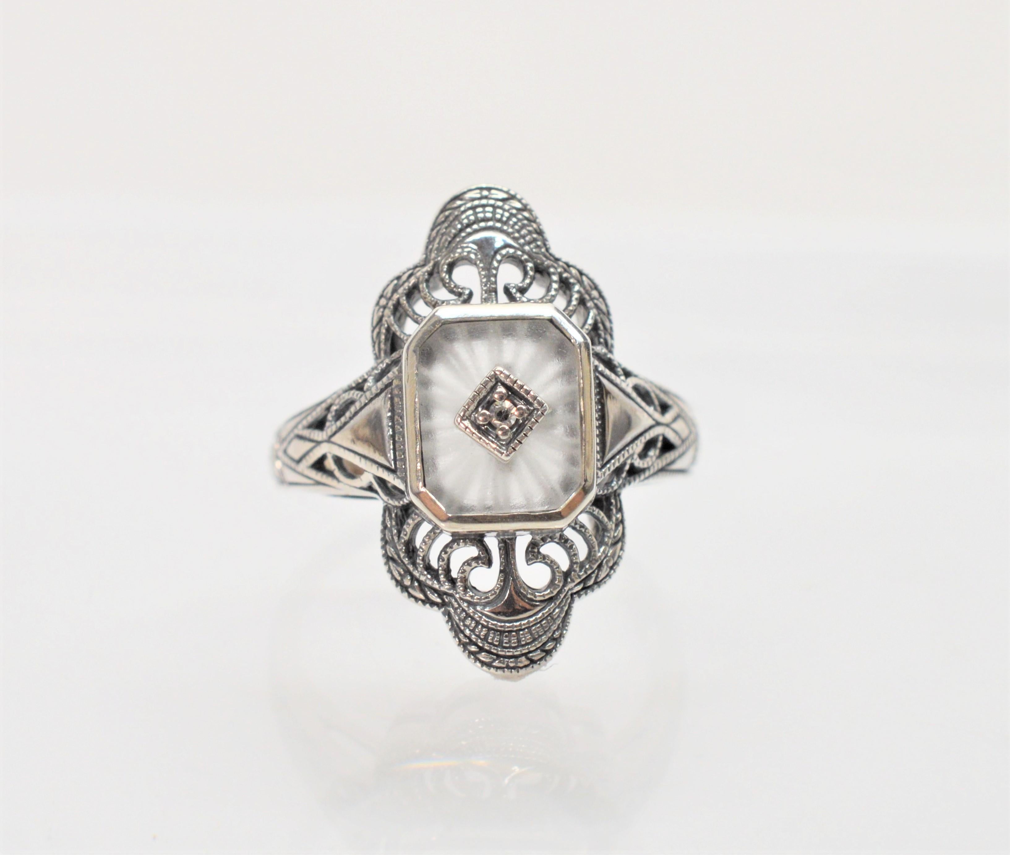 Sunray frosted camphor glass with a center diamond accent is framed with intricate .925 sterling silver filigree in the style of the Victorian period.
In size 7.5. New and presented in a miniature antique style gift box.