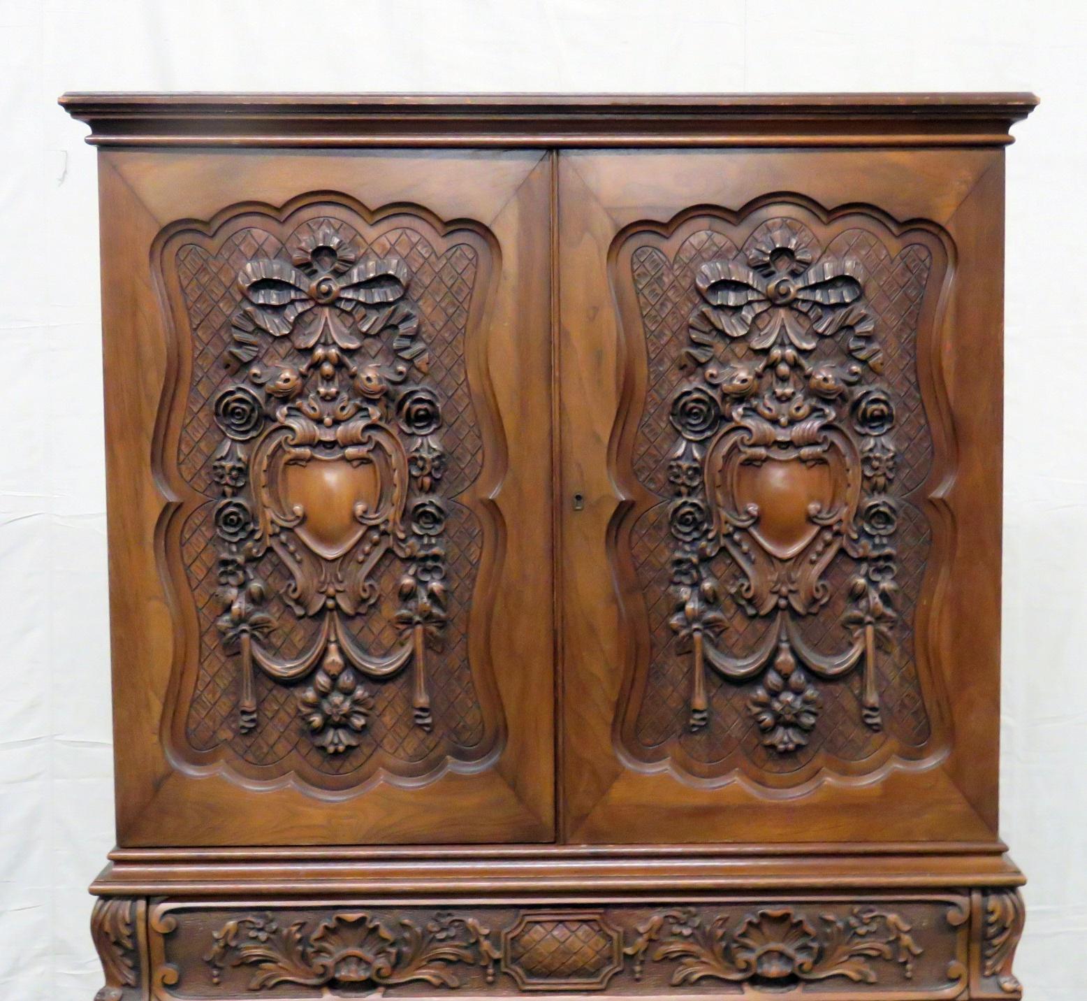 This is a beautifully designed and incredibly carved Georgian style carved liquor cabinet with 2 doors containing 2 shelves over 1 drawer.