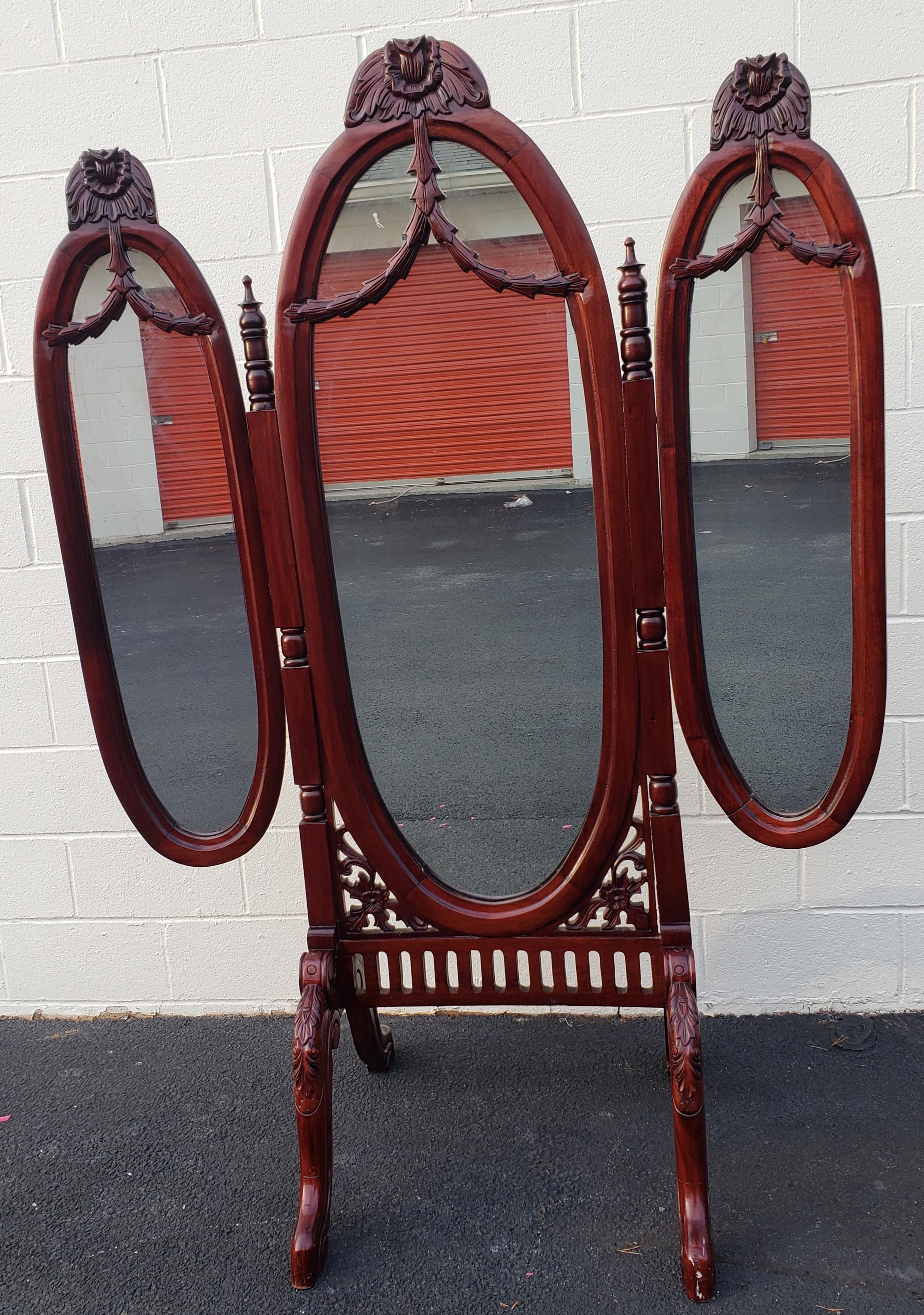 This tri-fold mirror features beautiful mahogany wood carvings. The mirror is self standing and very steady with the large base. The left and right mirror swing out from the center.
The mirror set is 51