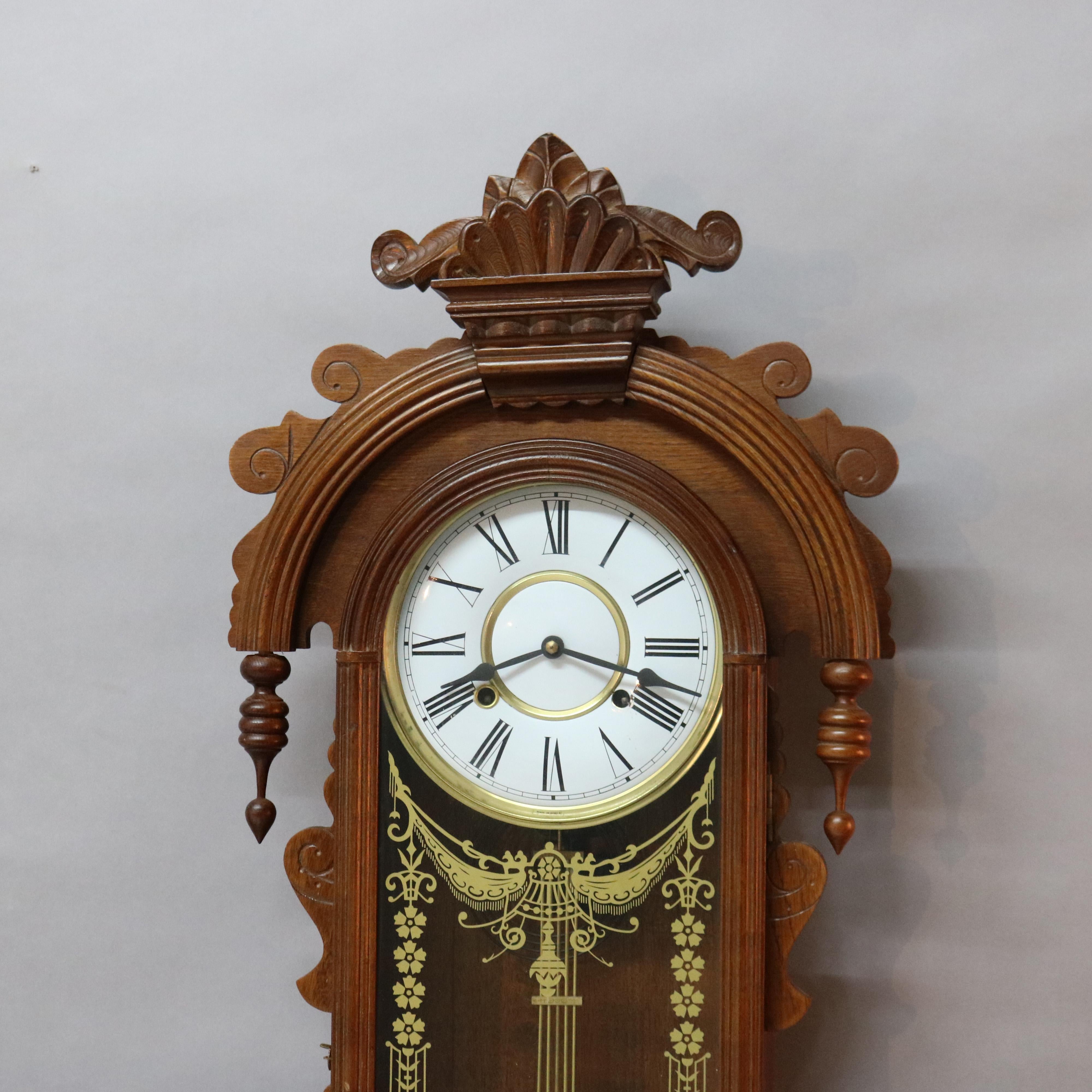 A Victorian style clock offers carved oak construction with carved foliate crest with flanking drop finials over case with single door with gilt decoration, 20th century

Measures - 36''H x 15.5''W x 5.5''D.

Catalogue Note: Ask about DISCOUNTED