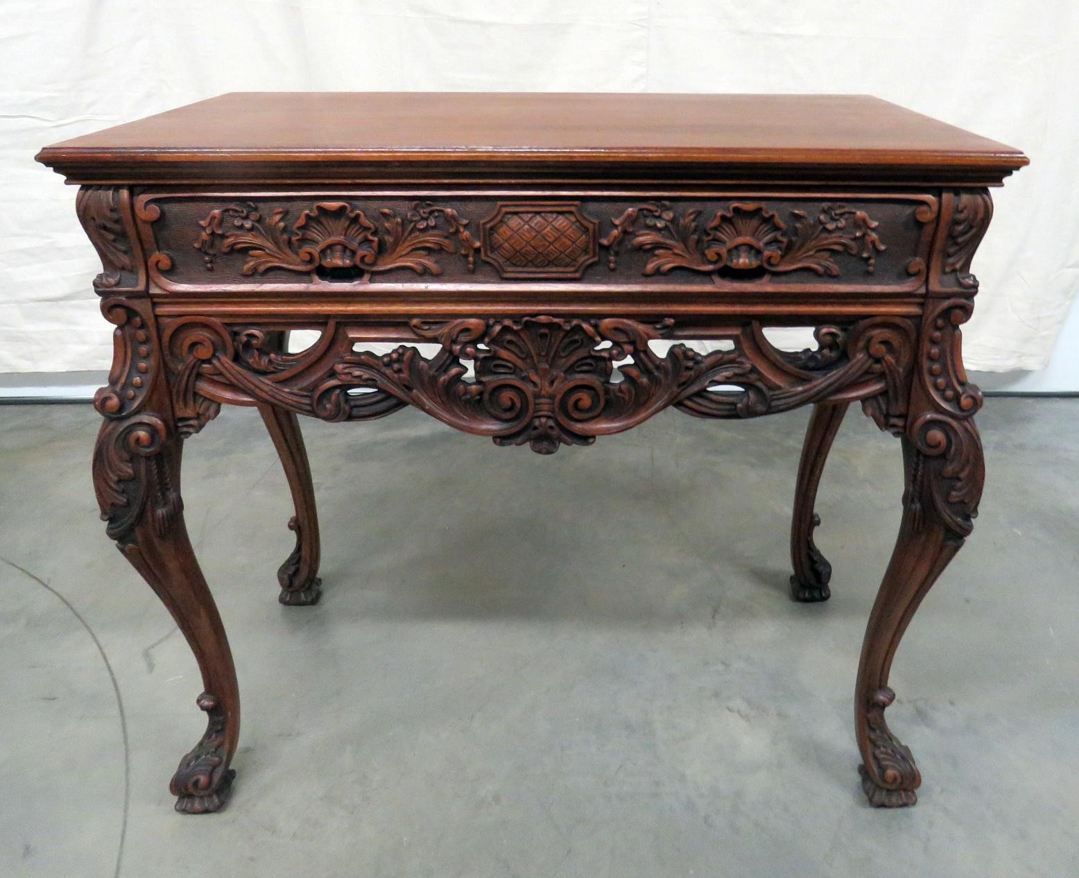 This is a gorgeous heavily carved server or buffet with incredible carving and attention to detail. The piece is a perfect mate to a larger sideboard listed separately. 