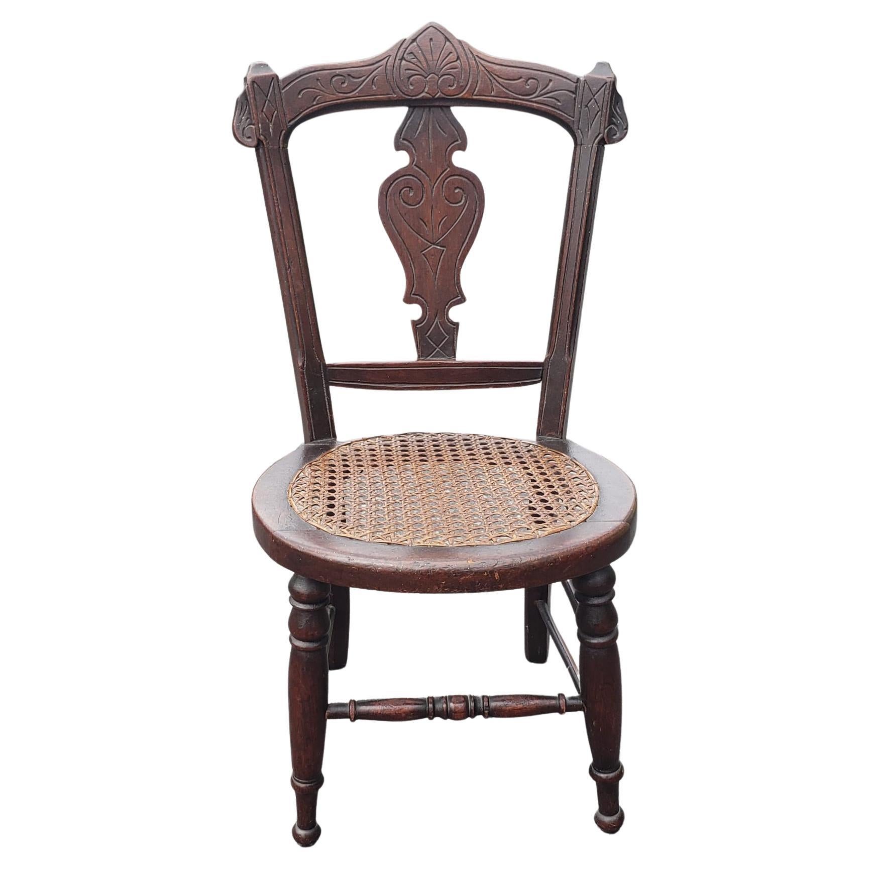 Victorian Style Carved Walnut and Cane Seat Youth Chair For Sale
