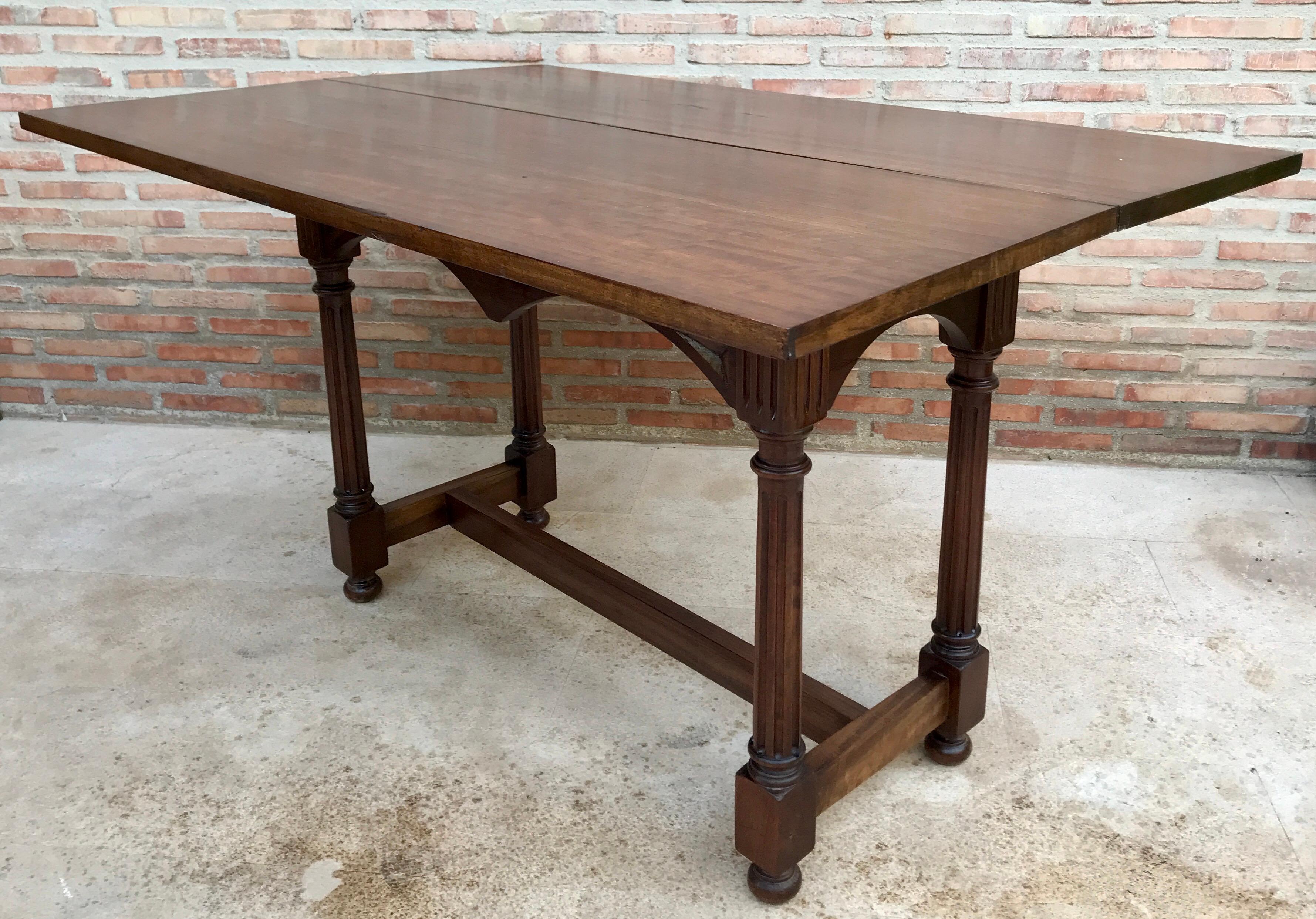 Large Victorian-style console in walnut wood with folding top convertible into a dining table, straight legs carved with drawings of straight lines, joined with a wooden frame.

Open Depth: 89cm 
Design Period 1920 to 1949 
Production Period