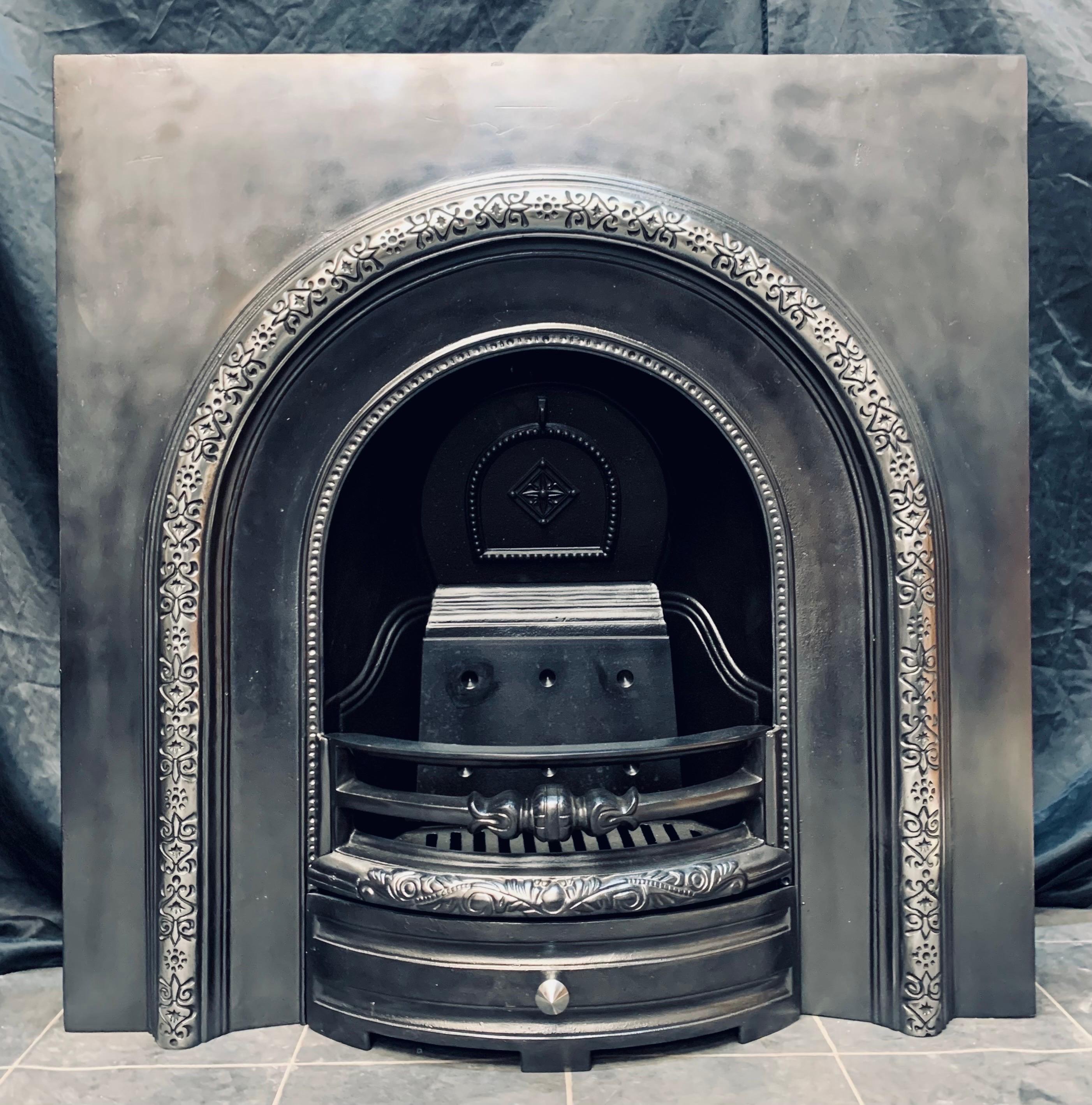 A simple Victorian style cast iron arched fireplace insert of good proportions. The highlighted front arch with generous outer plate, complete with the original damper plate, ash pan tray, and door. 
Would suit a variety of rooms and decors.
