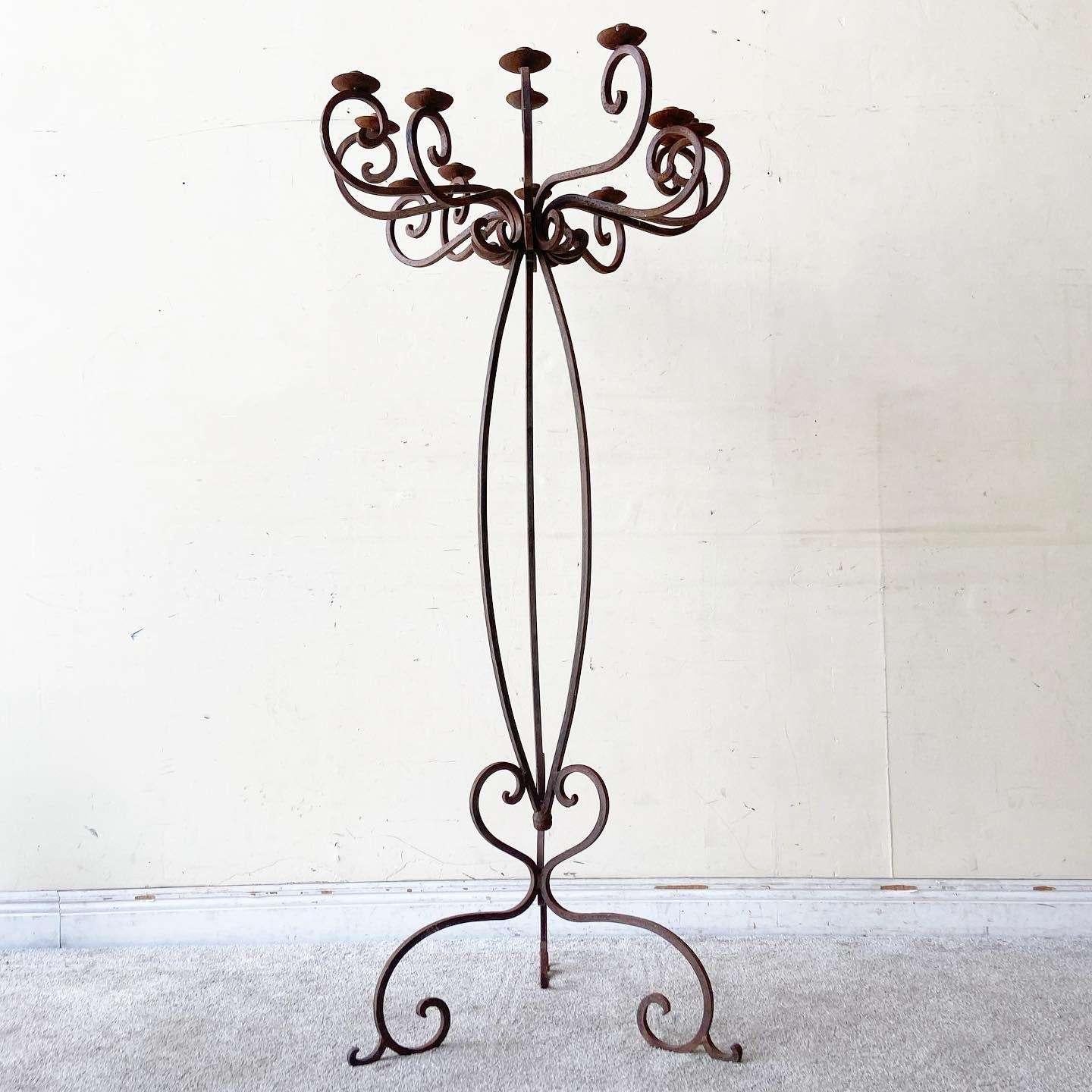 Amazing vintage Victorian style 13 cup candelabra. Features a black finish which has weathered and pitting consistently throughout the entire piece. Displays 13 ornate curved candle cups.
