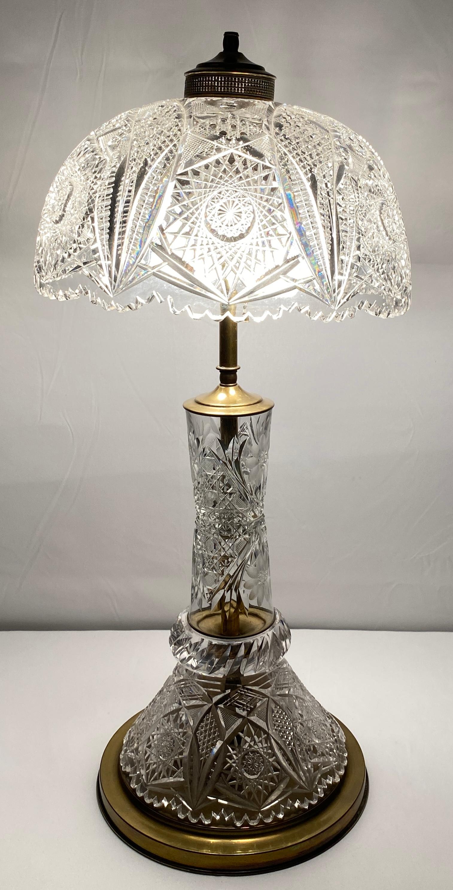 Brilliant cut crystal table lamp, the mushroom shape dome. Finely wheel cut  shade with diamond shaped patterns encircled by ring of prisms over conforming baluster formed brass base.

This fine crystal table lamp in the Victorian style has some